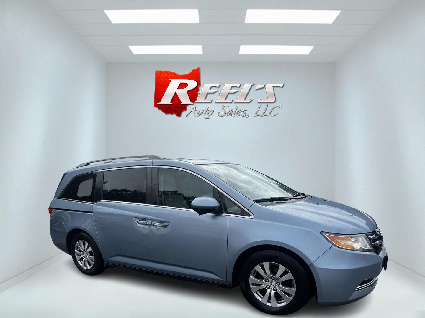 2014 Blue /Tan Honda Odyssey EX-L (5FNRL5H6XEB) with an 3.5L V6 SOHC 24V engine, 6-Speed Automatic transmission, located at 547 E. Main St., Orwell, OH, 44076, (440) 437-5893, 41.535435, -80.847855 - This 2014 Honda Odyssey EX-L is a well-equipped minivan featuring a powerful 3.5-liter SOHC V6 engine with VTEC technology, paired with a 6-speed automatic transmission. It offers a blend of comfort and safety features, including tri-zone automatic climate control, leather interior, heated and power - Photo#3