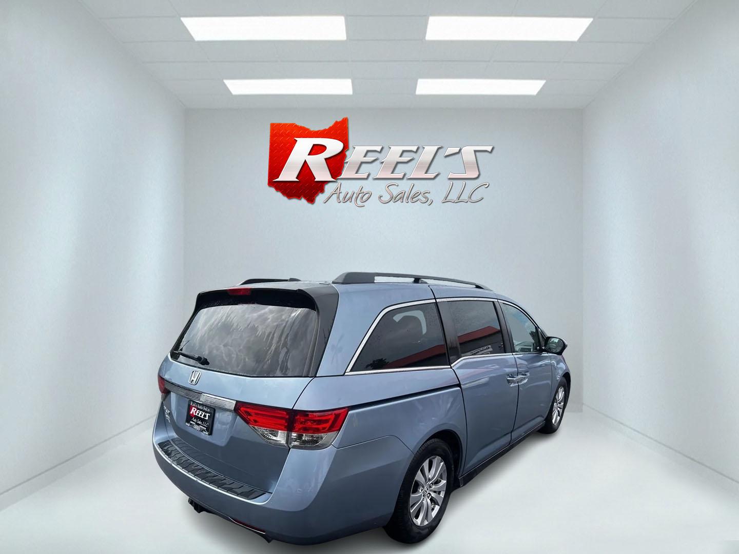 2014 Blue /Tan Honda Odyssey EX-L (5FNRL5H6XEB) with an 3.5L V6 SOHC 24V engine, 6-Speed Automatic transmission, located at 547 E. Main St., Orwell, OH, 44076, (440) 437-5893, 41.535435, -80.847855 - This 2014 Honda Odyssey EX-L is a well-equipped minivan featuring a powerful 3.5-liter SOHC V6 engine with VTEC technology, paired with a 6-speed automatic transmission. It offers a blend of comfort and safety features, including tri-zone automatic climate control, leather interior, heated and power - Photo#5