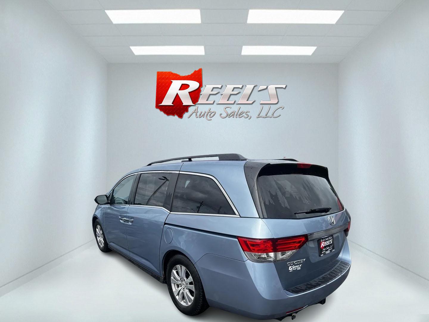 2014 Blue /Tan Honda Odyssey EX-L (5FNRL5H6XEB) with an 3.5L V6 SOHC 24V engine, 6-Speed Automatic transmission, located at 547 E. Main St., Orwell, OH, 44076, (440) 437-5893, 41.535435, -80.847855 - This 2014 Honda Odyssey EX-L is a well-equipped minivan featuring a powerful 3.5-liter SOHC V6 engine with VTEC technology, paired with a 6-speed automatic transmission. It offers a blend of comfort and safety features, including tri-zone automatic climate control, leather interior, heated and power - Photo#7