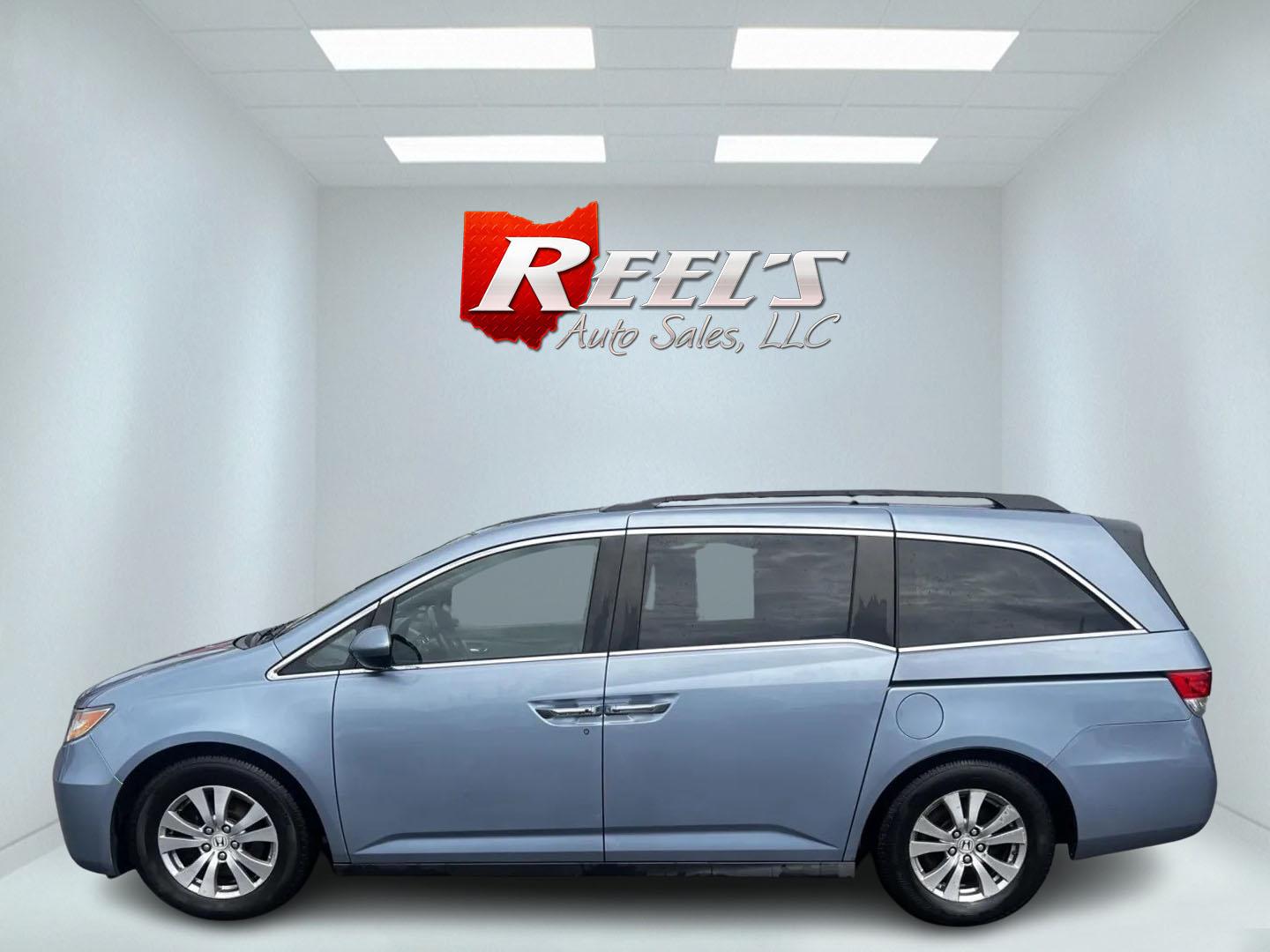 2014 Blue /Tan Honda Odyssey EX-L (5FNRL5H6XEB) with an 3.5L V6 SOHC 24V engine, 6-Speed Automatic transmission, located at 547 E. Main St., Orwell, OH, 44076, (440) 437-5893, 41.535435, -80.847855 - This 2014 Honda Odyssey EX-L is a well-equipped minivan featuring a powerful 3.5-liter SOHC V6 engine with VTEC technology, paired with a 6-speed automatic transmission. It offers a blend of comfort and safety features, including tri-zone automatic climate control, leather interior, heated and power - Photo#9