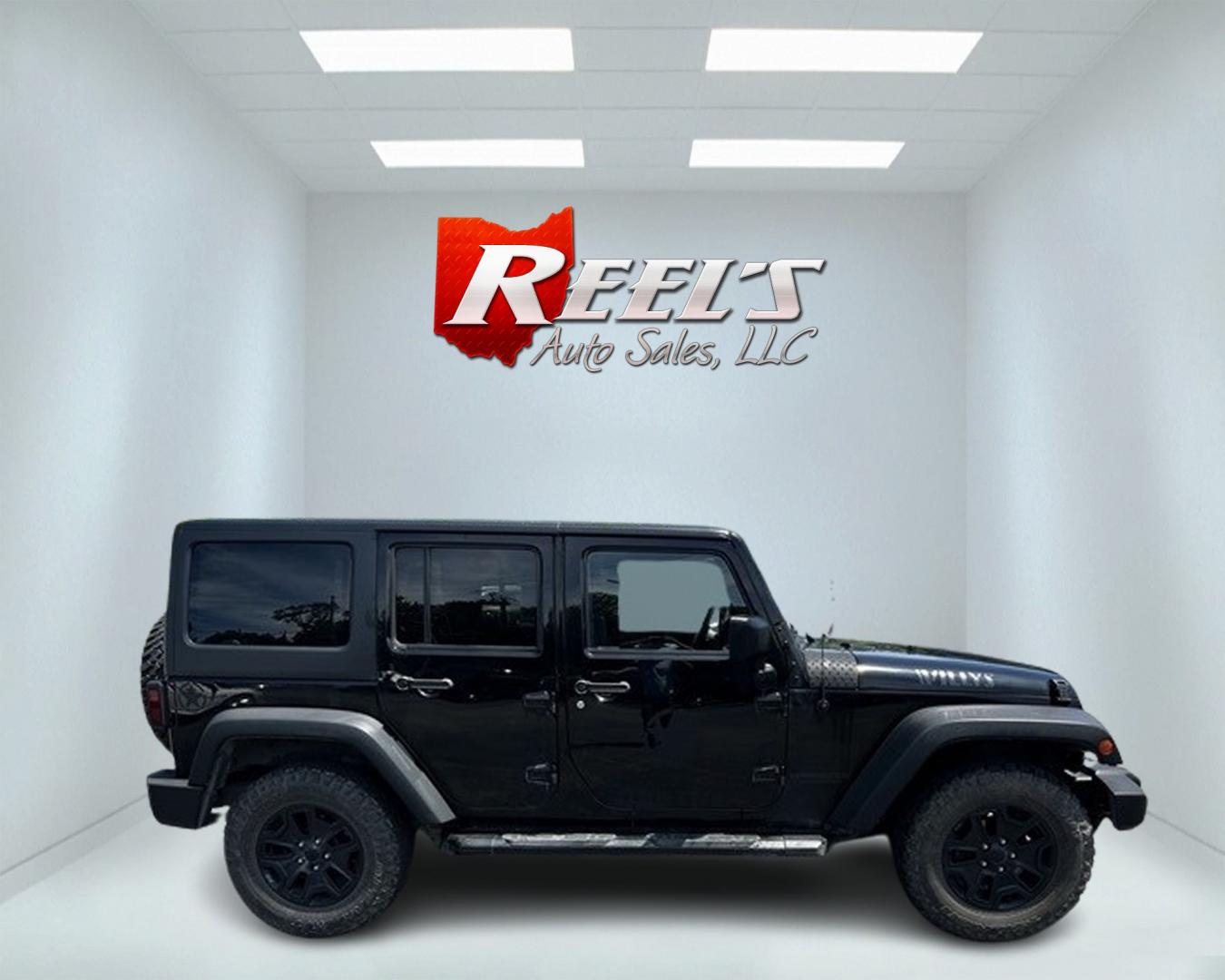 2015 Black /Black Jeep Wrangler Unlimited Willys 4WD (1C4BJWDG9FL) with an 3.6L V6 DOHC 24V engine, 6 Speed Manual transmission, located at 547 E. Main St., Orwell, OH, 44076, (440) 437-5893, 41.535435, -80.847855 - This 2015 Jeep Wrangler Unlimited Willy Wheeler Edition is a capable and well-equipped off-road vehicle. It features a 3.6-liter Pentastar V6 engine paired with a 6-speed manual transmission, offering a traditional driving experience favored by many off-road enthusiasts. The vehicle comes with sever - Photo#4