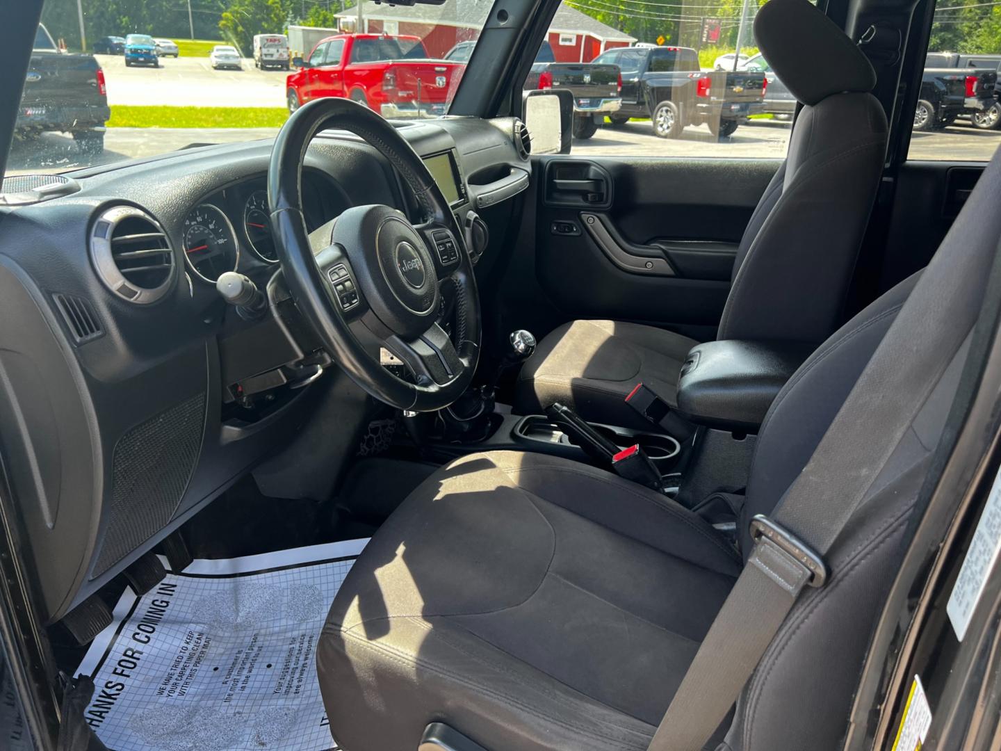 2015 Black /Black Jeep Wrangler Unlimited Willys 4WD (1C4BJWDG9FL) with an 3.6L V6 DOHC 24V engine, 6 Speed Manual transmission, located at 547 E. Main St., Orwell, OH, 44076, (440) 437-5893, 41.535435, -80.847855 - This 2015 Jeep Wrangler Unlimited Willy Wheeler Edition is a capable and well-equipped off-road vehicle. It features a 3.6-liter Pentastar V6 engine paired with a 6-speed manual transmission, offering a traditional driving experience favored by many off-road enthusiasts. The vehicle comes with sever - Photo#15