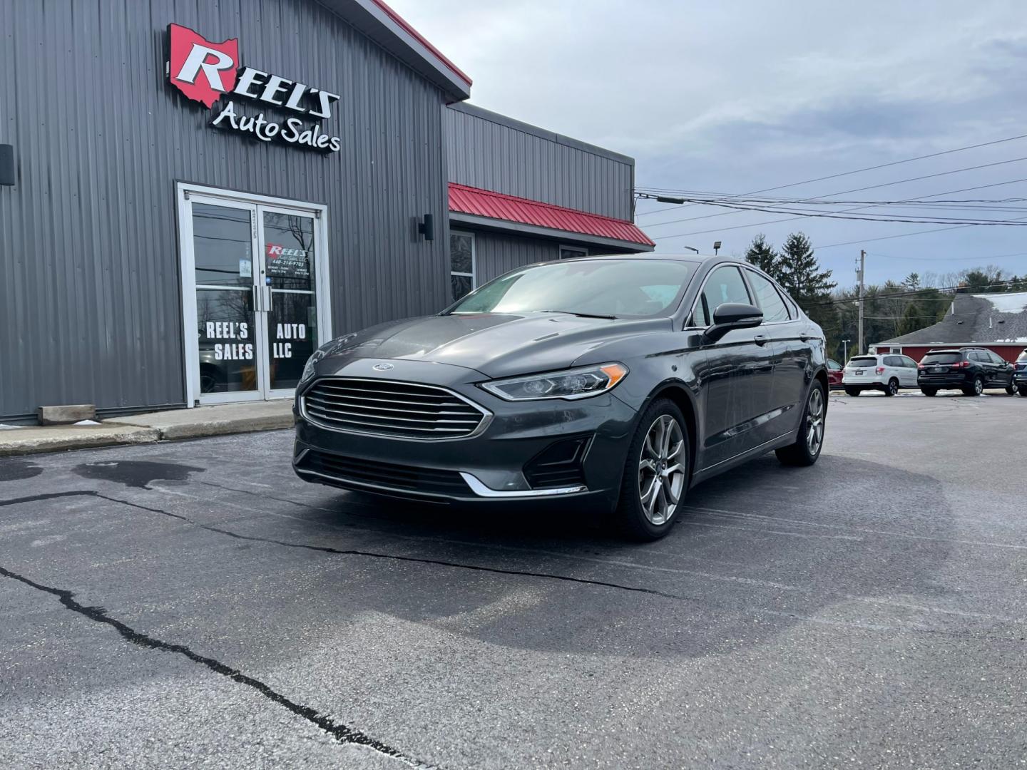 2019 Gray /Black Ford Fusion SEL (3FA6P0CD5KR) with an 1.5L I4 DOHC 16V TURBO engine, 6A transmission, located at 547 E. Main St., Orwell, OH, 44076, (440) 437-5893, 41.535435, -80.847855 - Photo#0