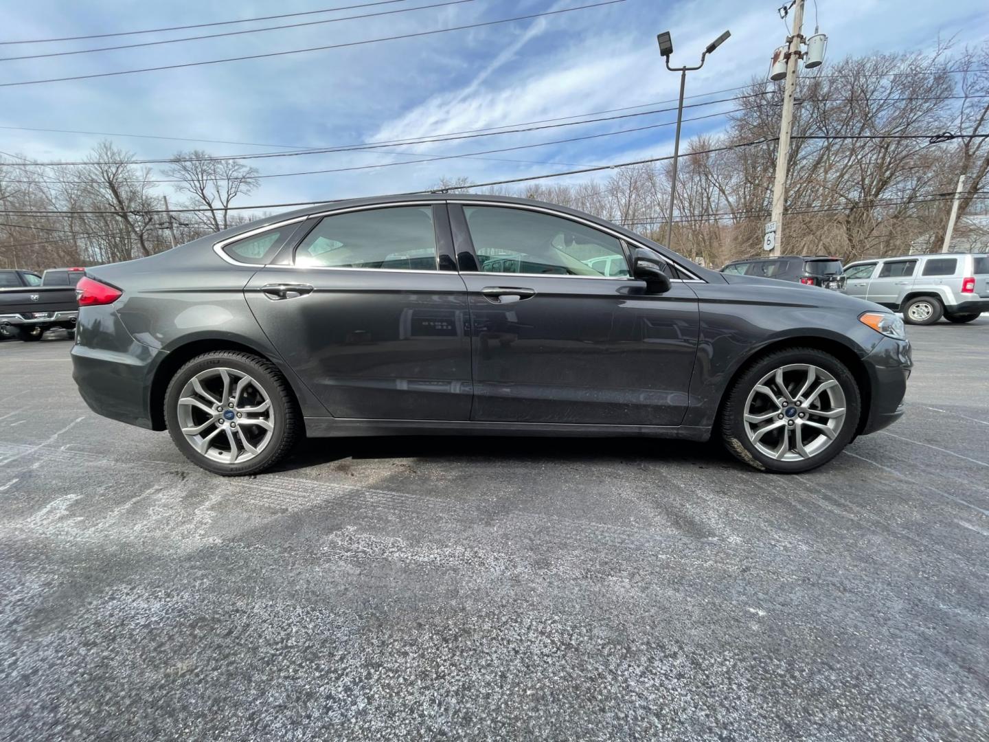 2019 Gray /Black Ford Fusion SEL (3FA6P0CD5KR) with an 1.5L I4 DOHC 16V TURBO engine, 6A transmission, located at 547 E. Main St., Orwell, OH, 44076, (440) 437-5893, 41.535435, -80.847855 - Photo#5