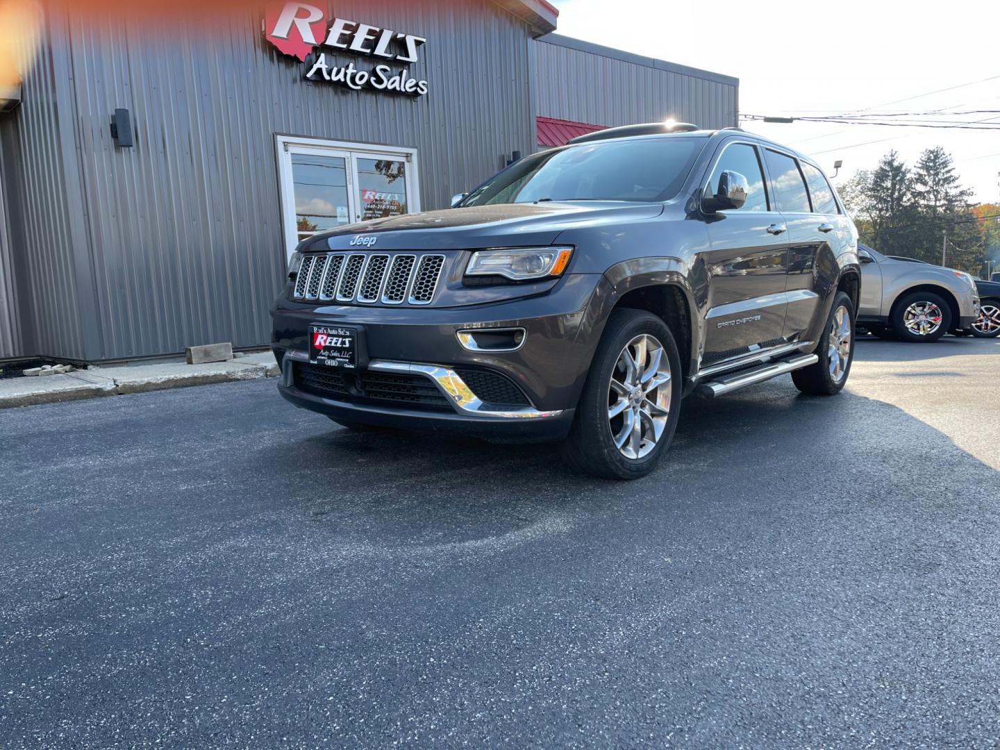 2015 Gray /Brown Jeep Grand Cherokee Summit 4WD (1C4RJFJG7FC) with an 3.6L V6 DOHC 24V FFV engine, 8-Speed Automatic transmission, located at 11115 Chardon Rd. , Chardon, OH, 44024, (440) 214-9705, 41.580246, -81.241943 - Photo#0