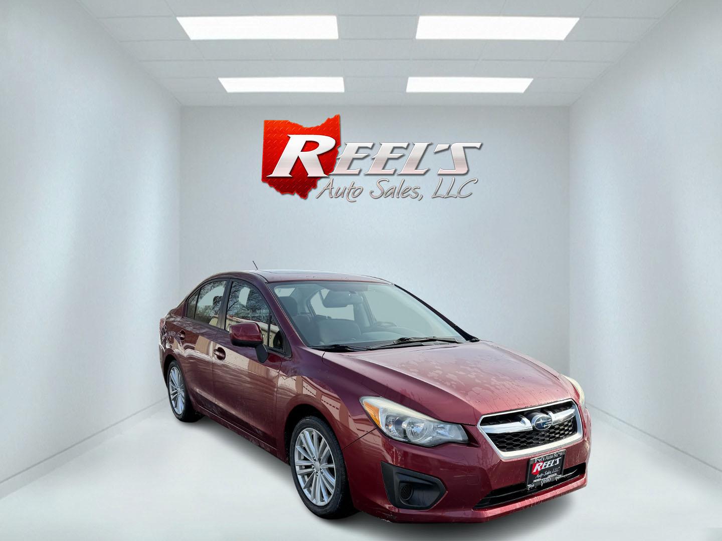 2013 Red /Black Subaru Impreza Premium (JF1GJAD60DH) with an 2.0L H4 DOHC 16V engine, Automatic transmission, located at 547 E. Main St., Orwell, OH, 44076, (440) 437-5893, 41.535435, -80.847855 - This 2013 Subaru Impreza Premium offers a robust combination of performance and efficiency, powered by a 2.0L H4 engine paired with Subaru's renowned Symmetrical All-Wheel Drive (AWD) system, providing excellent traction and stability across various driving conditions. This model achieves an impress - Photo#2