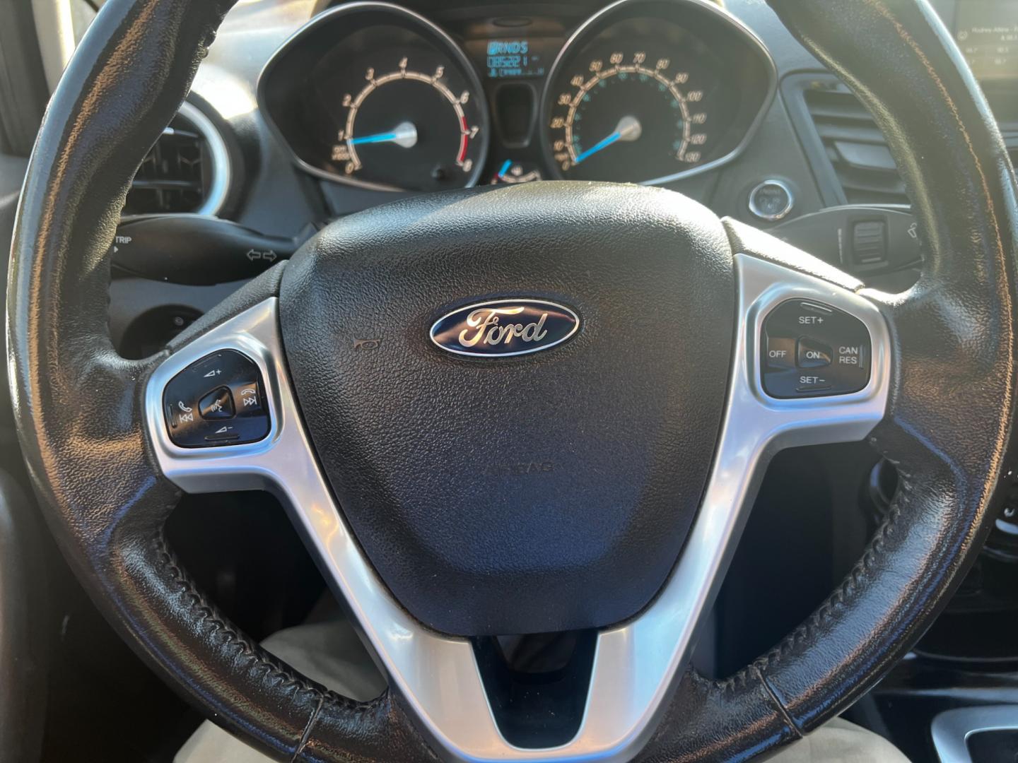 2014 Gray /Black Ford Fiesta Titanium Hatchback (3FADP4FJ3EM) with an 1.6L I4 DOHC 16V engine, 6 Speed Automatic transmission, located at 547 E. Main St., Orwell, OH, 44076, (440) 437-5893, 41.535435, -80.847855 - This 2014 Ford Fiesta Titanium is a compact car that features a 1.6L I4 Duratec engine paired with a 6-speed automatic transmission. The interior is wrapped in premium leather and includes heated front seats, automatic climate control, and a range of comfort features. The exterior is equipped with d - Photo#21