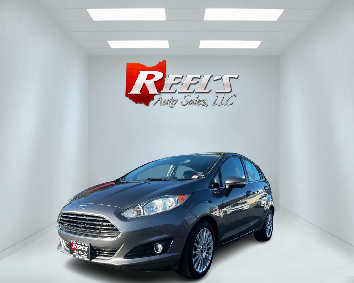 2014 Gray /Black Ford Fiesta Titanium Hatchback (3FADP4FJ3EM) with an 1.6L I4 DOHC 16V engine, 6 Speed Automatic transmission, located at 547 E. Main St., Orwell, OH, 44076, (440) 437-5893, 41.535435, -80.847855 - This 2014 Ford Fiesta Titanium is a compact car that features a 1.6L I4 Duratec engine paired with a 6-speed automatic transmission. The interior is wrapped in premium leather and includes heated front seats, automatic climate control, and a range of comfort features. The exterior is equipped with d - Photo#0