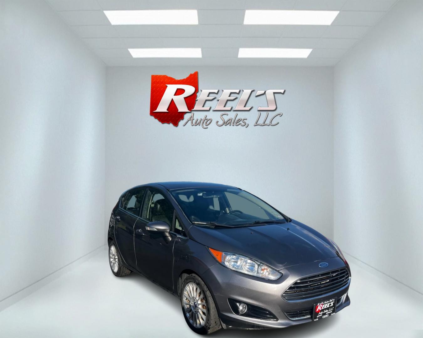 2014 Gray /Black Ford Fiesta Titanium Hatchback (3FADP4FJ3EM) with an 1.6L I4 DOHC 16V engine, 6 Speed Automatic transmission, located at 547 E. Main St., Orwell, OH, 44076, (440) 437-5893, 41.535435, -80.847855 - This 2014 Ford Fiesta Titanium is a compact car that features a 1.6L I4 Duratec engine paired with a 6-speed automatic transmission. The interior is wrapped in premium leather and includes heated front seats, automatic climate control, and a range of comfort features. The exterior is equipped with d - Photo#2