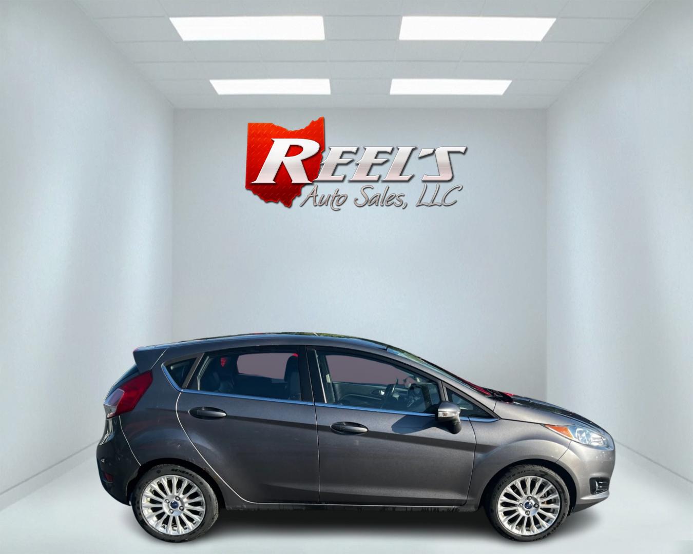 2014 Gray /Black Ford Fiesta Titanium Hatchback (3FADP4FJ3EM) with an 1.6L I4 DOHC 16V engine, 6 Speed Automatic transmission, located at 547 E. Main St., Orwell, OH, 44076, (440) 437-5893, 41.535435, -80.847855 - This 2014 Ford Fiesta Titanium is a compact car that features a 1.6L I4 Duratec engine paired with a 6-speed automatic transmission. The interior is wrapped in premium leather and includes heated front seats, automatic climate control, and a range of comfort features. The exterior is equipped with d - Photo#4