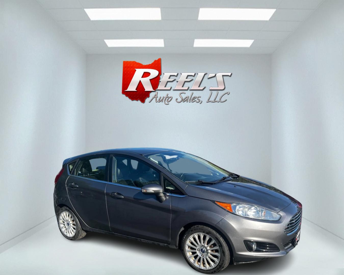 2014 Gray /Black Ford Fiesta Titanium Hatchback (3FADP4FJ3EM) with an 1.6L I4 DOHC 16V engine, 6 Speed Automatic transmission, located at 547 E. Main St., Orwell, OH, 44076, (440) 437-5893, 41.535435, -80.847855 - This 2014 Ford Fiesta Titanium is a compact car that features a 1.6L I4 Duratec engine paired with a 6-speed automatic transmission. The interior is wrapped in premium leather and includes heated front seats, automatic climate control, and a range of comfort features. The exterior is equipped with d - Photo#3