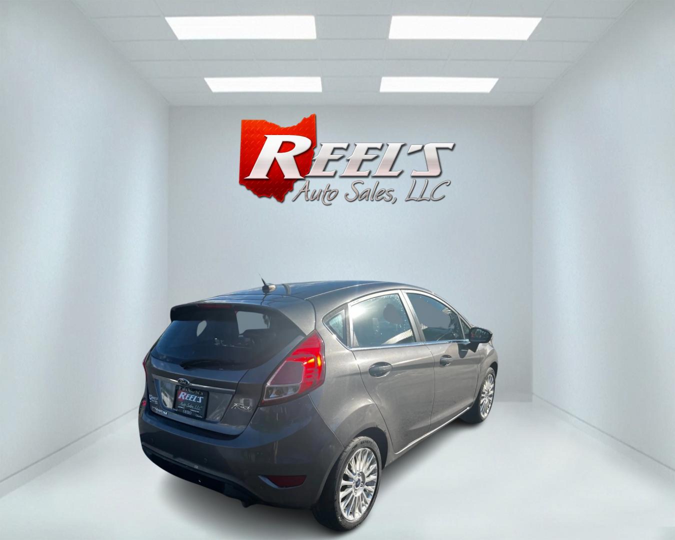 2014 Gray /Black Ford Fiesta Titanium Hatchback (3FADP4FJ3EM) with an 1.6L I4 DOHC 16V engine, 6 Speed Automatic transmission, located at 547 E. Main St., Orwell, OH, 44076, (440) 437-5893, 41.535435, -80.847855 - This 2014 Ford Fiesta Titanium is a compact car that features a 1.6L I4 Duratec engine paired with a 6-speed automatic transmission. The interior is wrapped in premium leather and includes heated front seats, automatic climate control, and a range of comfort features. The exterior is equipped with d - Photo#5