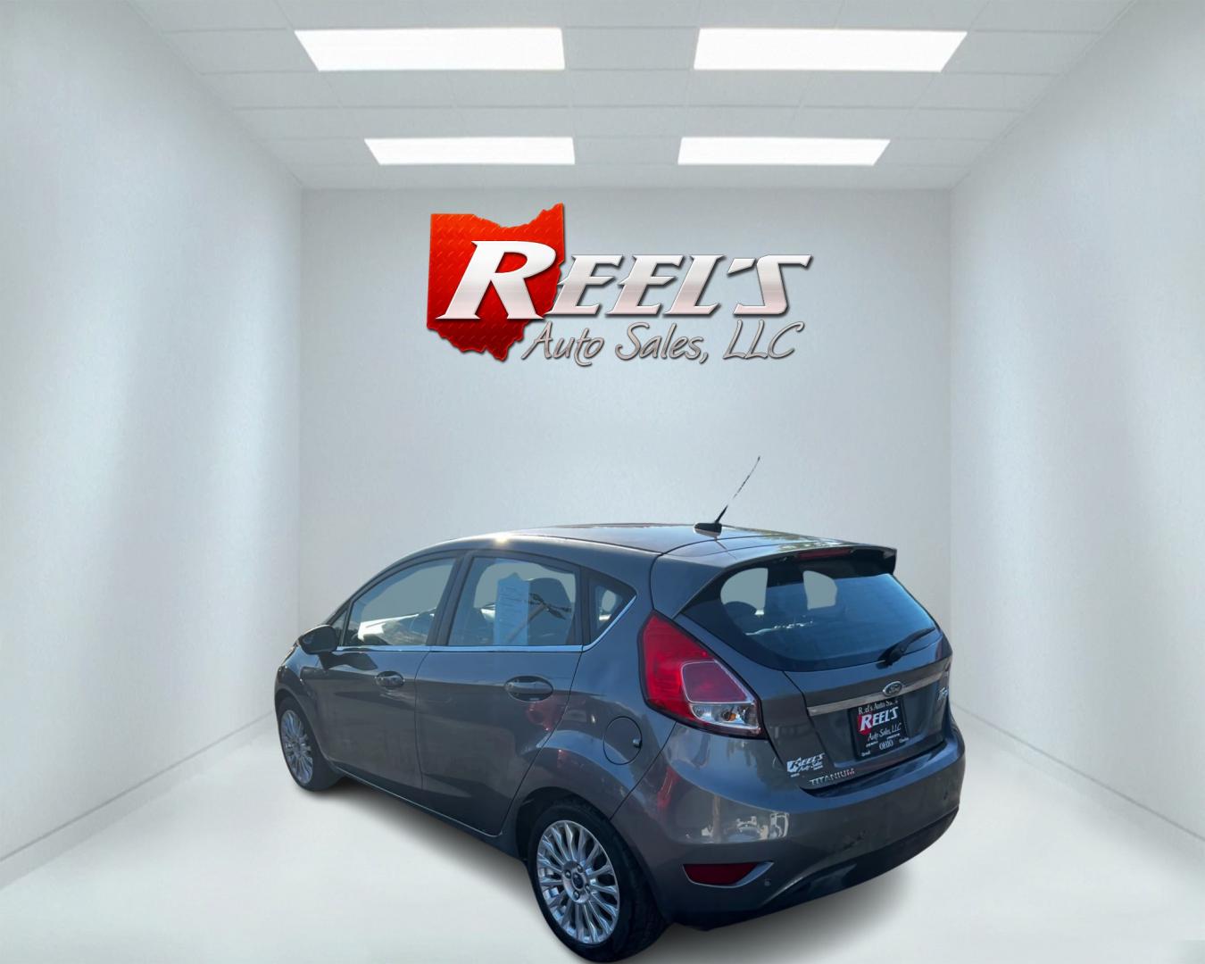 2014 Gray /Black Ford Fiesta Titanium Hatchback (3FADP4FJ3EM) with an 1.6L I4 DOHC 16V engine, 6 Speed Automatic transmission, located at 547 E. Main St., Orwell, OH, 44076, (440) 437-5893, 41.535435, -80.847855 - This 2014 Ford Fiesta Titanium is a compact car that features a 1.6L I4 Duratec engine paired with a 6-speed automatic transmission. The interior is wrapped in premium leather and includes heated front seats, automatic climate control, and a range of comfort features. The exterior is equipped with d - Photo#7