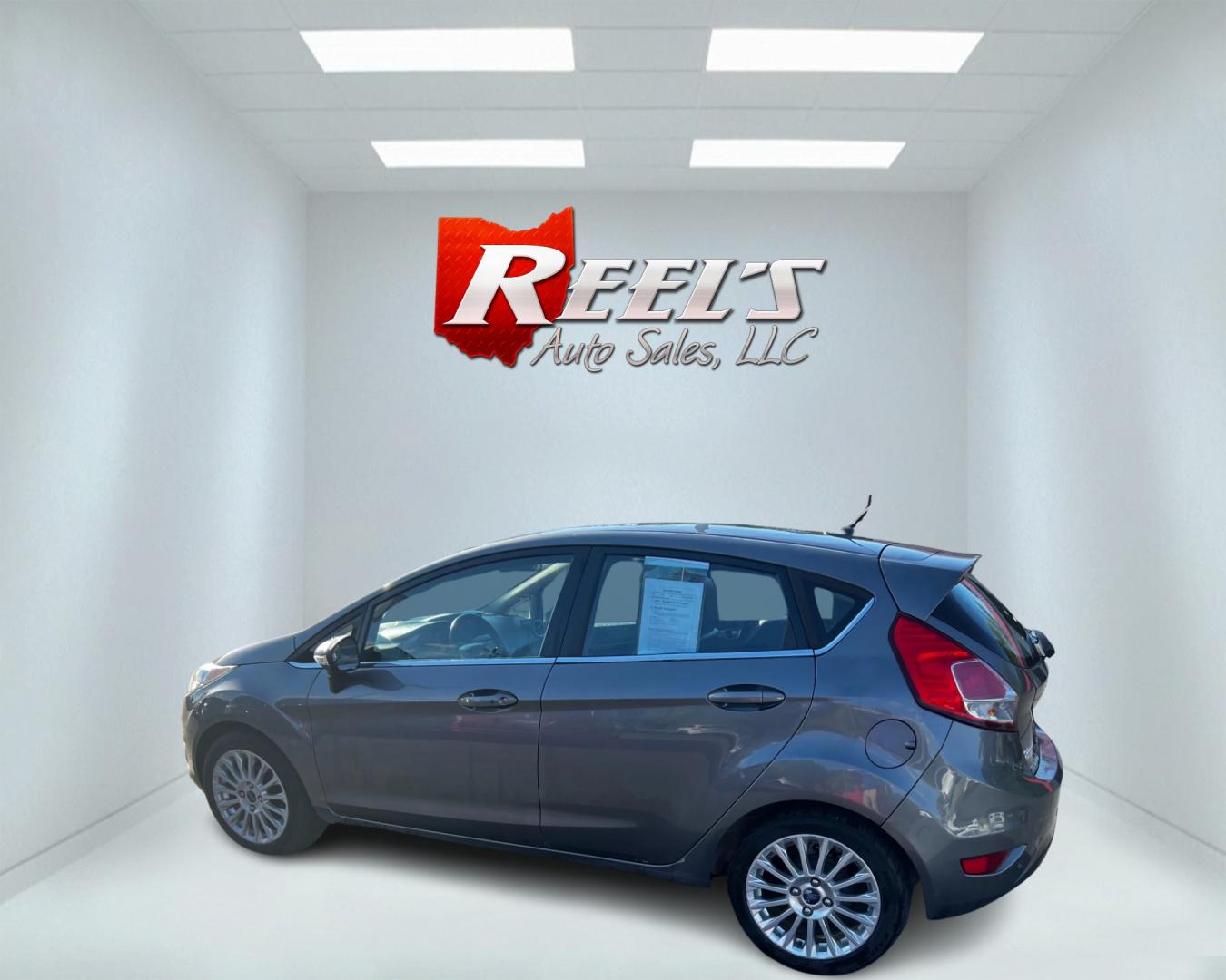 2014 Gray /Black Ford Fiesta Titanium Hatchback (3FADP4FJ3EM) with an 1.6L I4 DOHC 16V engine, 6 Speed Automatic transmission, located at 547 E. Main St., Orwell, OH, 44076, (440) 437-5893, 41.535435, -80.847855 - This 2014 Ford Fiesta Titanium is a compact car that features a 1.6L I4 Duratec engine paired with a 6-speed automatic transmission. The interior is wrapped in premium leather and includes heated front seats, automatic climate control, and a range of comfort features. The exterior is equipped with d - Photo#8