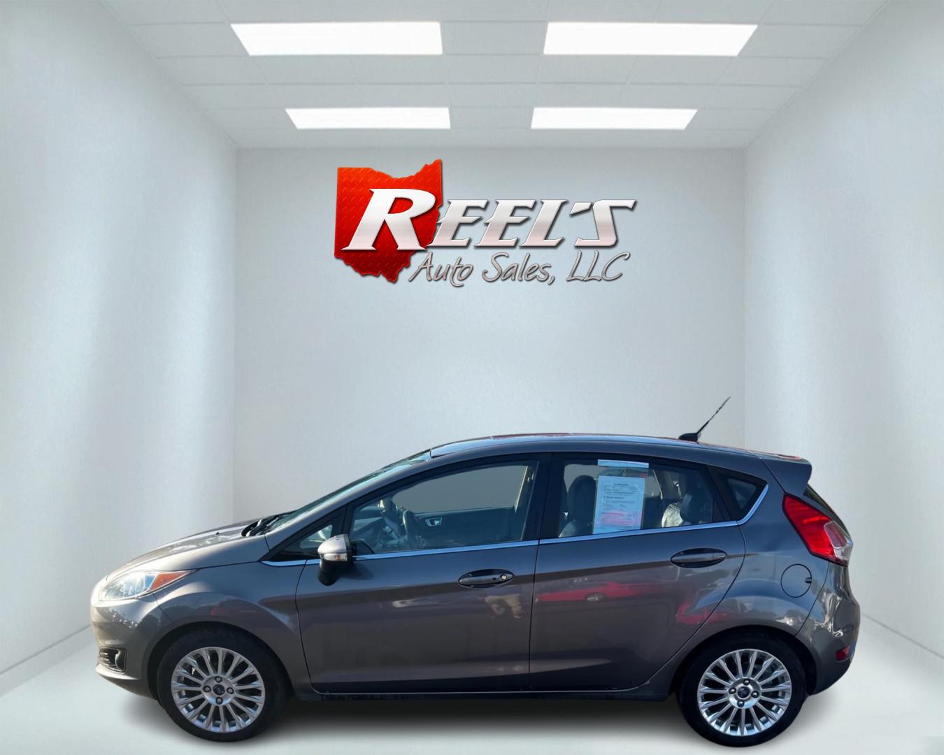 2014 Gray /Black Ford Fiesta Titanium Hatchback (3FADP4FJ3EM) with an 1.6L I4 DOHC 16V engine, 6 Speed Automatic transmission, located at 547 E. Main St., Orwell, OH, 44076, (440) 437-5893, 41.535435, -80.847855 - This 2014 Ford Fiesta Titanium is a compact car that features a 1.6L I4 Duratec engine paired with a 6-speed automatic transmission. The interior is wrapped in premium leather and includes heated front seats, automatic climate control, and a range of comfort features. The exterior is equipped with d - Photo#9