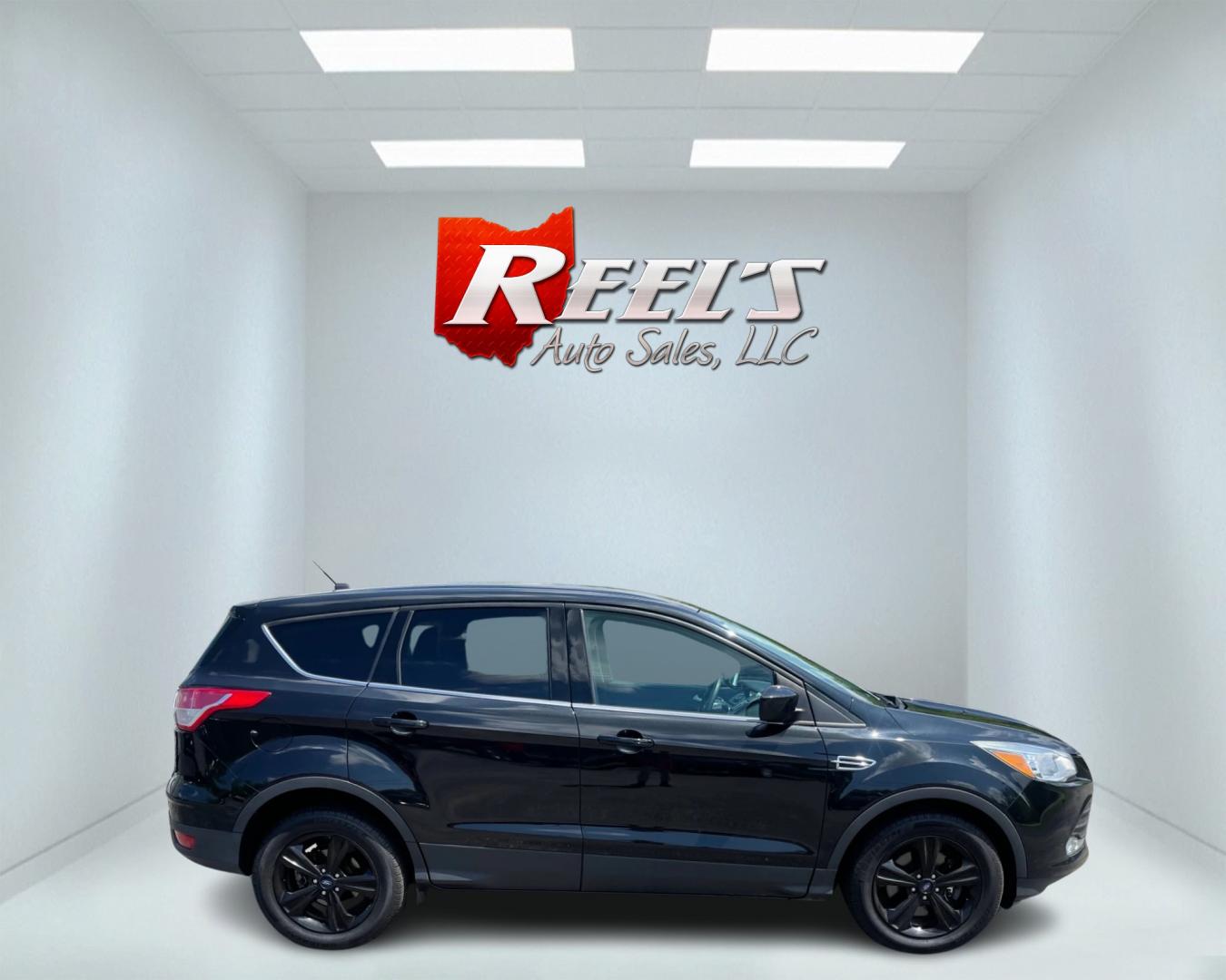 2015 Black /Black Ford Escape SE 4WD (1FMCU9GX4FU) with an 1.6L I4 DOHC 16V TURBO engine, 6-Speed Automatic transmission, located at 11115 Chardon Rd. , Chardon, OH, 44024, (440) 214-9705, 41.580246, -81.241943 - This 2015 Ford Escape SE 4WD, equipped with a 1.6L I4 Turbocharged EcoBoost engine and a 6-speed automatic transmission, offers a compelling blend of performance and efficiency. Key features include daytime running lights, dusk-sensing headlights, a power driver's seat, and a backup camera, with an - Photo#4