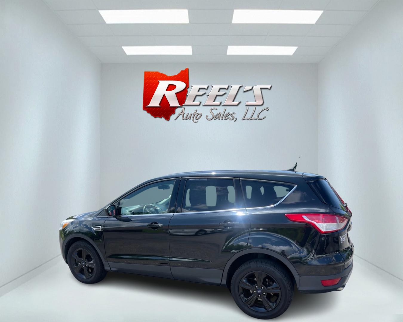 2015 Black /Black Ford Escape SE 4WD (1FMCU9GX4FU) with an 1.6L I4 DOHC 16V TURBO engine, 6-Speed Automatic transmission, located at 11115 Chardon Rd. , Chardon, OH, 44024, (440) 214-9705, 41.580246, -81.241943 - This 2015 Ford Escape SE 4WD, equipped with a 1.6L I4 Turbocharged EcoBoost engine and a 6-speed automatic transmission, offers a compelling blend of performance and efficiency. Key features include daytime running lights, dusk-sensing headlights, a power driver's seat, and a backup camera, with an - Photo#8