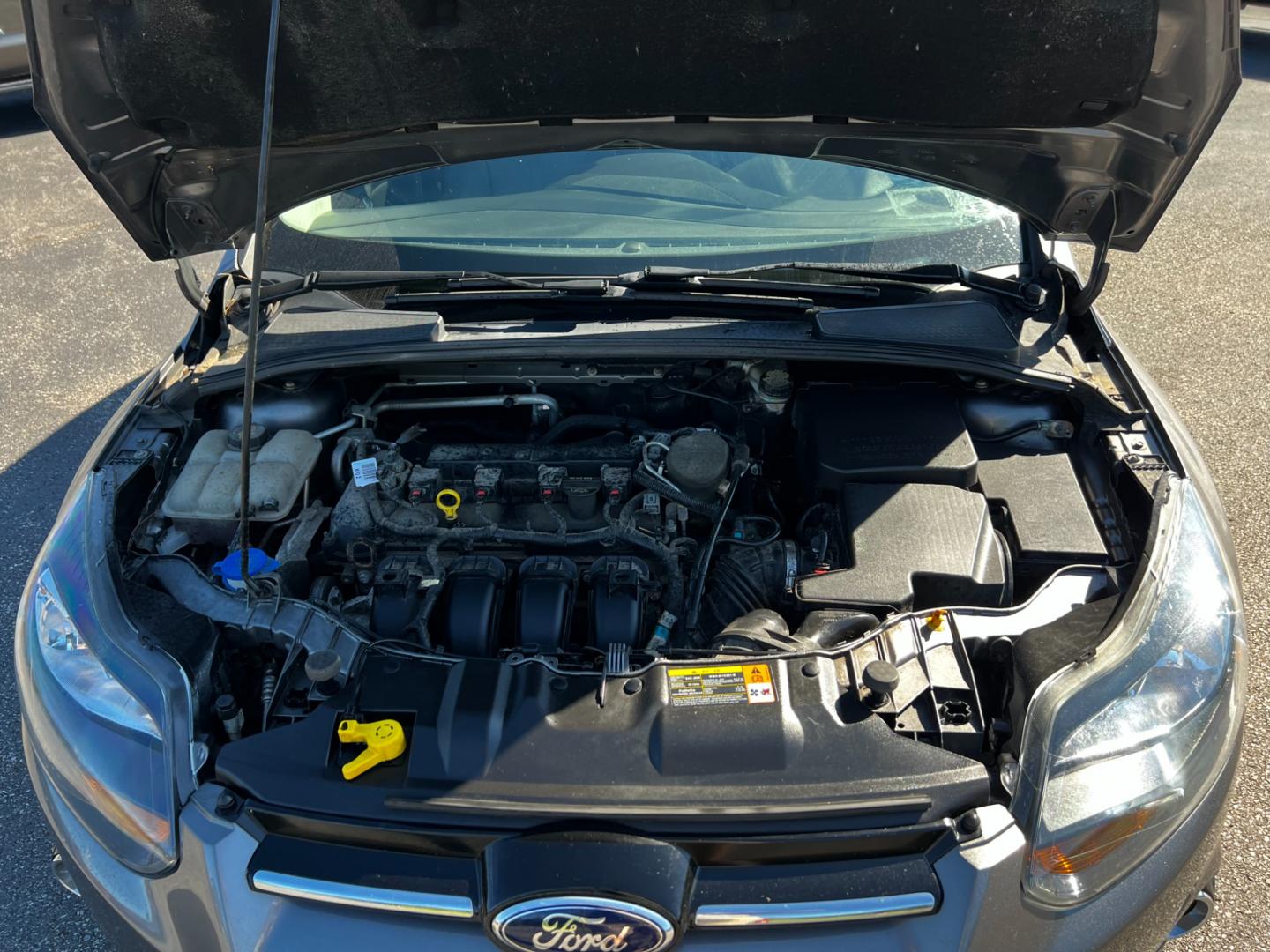 2014 Gray /Black Ford Focus Titanium Sedan (1FADP3J27EL) with an 2.0L I4 DOHC 16V engine, 6-Speed Automatic transmission, located at 11115 Chardon Rd. , Chardon, OH, 44024, (440) 214-9705, 41.580246, -81.241943 - This 2014 Ford Focus Titanium is a well-equipped compact car featuring a 2.0L I4 engine paired with a 6-speed automatic transmission. It boasts a leather interior, backup camera, backup sensors, remote start, dual-zone automatic climate control, and an 8-inch touch screen. Additional highlights incl - Photo#15