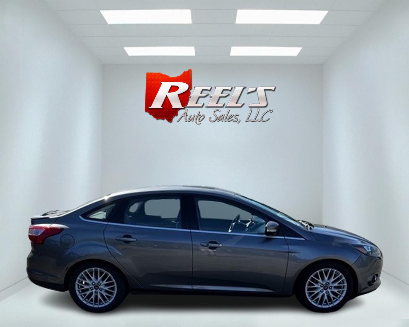 2014 Gray /Black Ford Focus Titanium Sedan (1FADP3J27EL) with an 2.0L I4 DOHC 16V engine, 6-Speed Automatic transmission, located at 11115 Chardon Rd. , Chardon, OH, 44024, (440) 214-9705, 41.580246, -81.241943 - This 2014 Ford Focus Titanium is a well-equipped compact car featuring a 2.0L I4 engine paired with a 6-speed automatic transmission. It boasts a leather interior, backup camera, backup sensors, remote start, dual-zone automatic climate control, and an 8-inch touch screen. Additional highlights incl - Photo#4