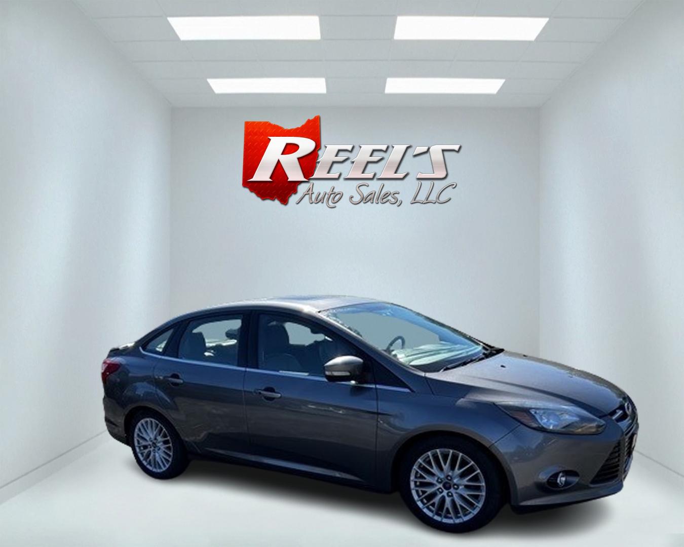 2014 Gray /Black Ford Focus Titanium Sedan (1FADP3J27EL) with an 2.0L I4 DOHC 16V engine, 6-Speed Automatic transmission, located at 11115 Chardon Rd. , Chardon, OH, 44024, (440) 214-9705, 41.580246, -81.241943 - This 2014 Ford Focus Titanium is a well-equipped compact car featuring a 2.0L I4 engine paired with a 6-speed automatic transmission. It boasts a leather interior, backup camera, backup sensors, remote start, dual-zone automatic climate control, and an 8-inch touch screen. Additional highlights incl - Photo#3