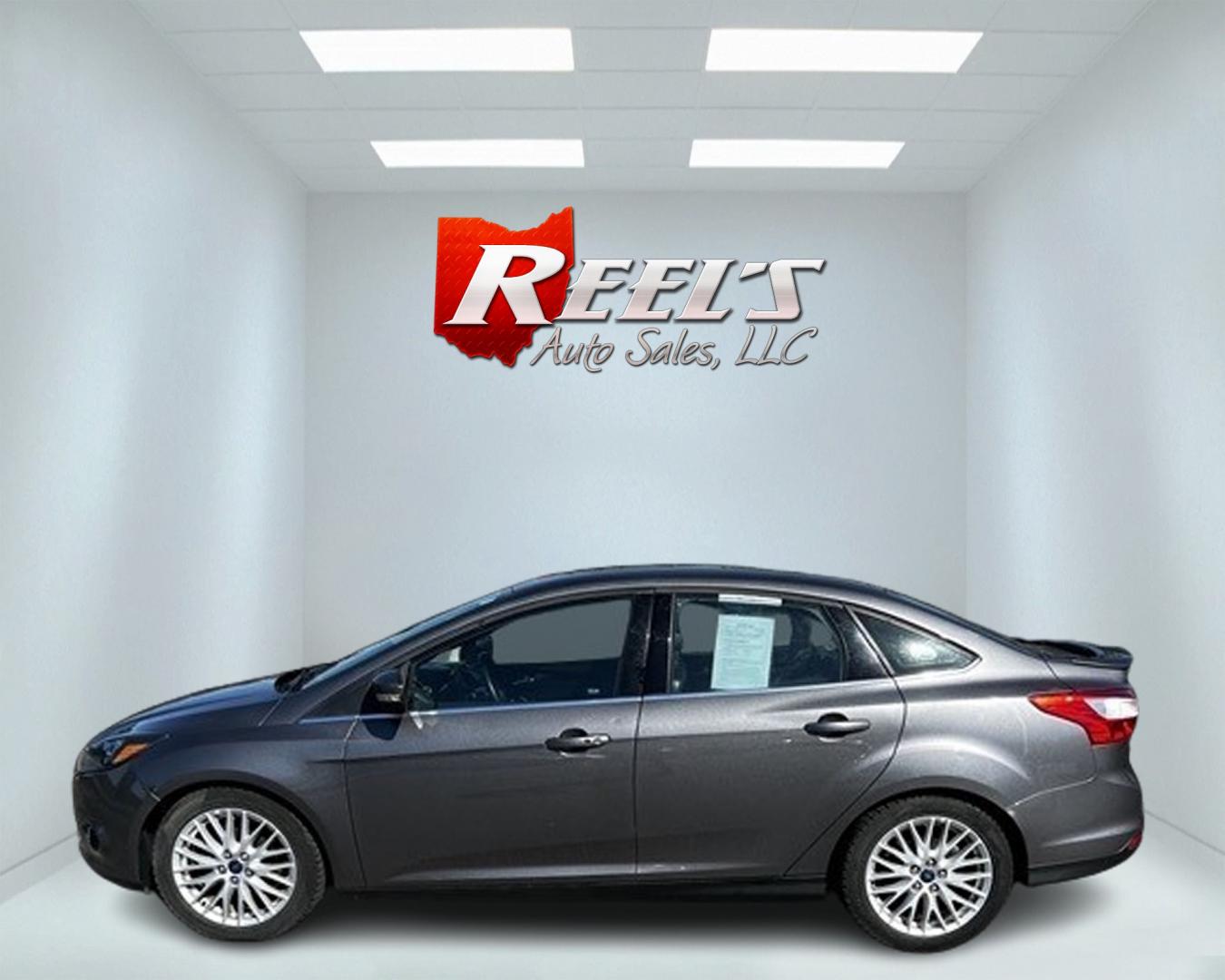 2014 Gray /Black Ford Focus Titanium Sedan (1FADP3J27EL) with an 2.0L I4 DOHC 16V engine, 6-Speed Automatic transmission, located at 11115 Chardon Rd. , Chardon, OH, 44024, (440) 214-9705, 41.580246, -81.241943 - This 2014 Ford Focus Titanium is a well-equipped compact car featuring a 2.0L I4 engine paired with a 6-speed automatic transmission. It boasts a leather interior, backup camera, backup sensors, remote start, dual-zone automatic climate control, and an 8-inch touch screen. Additional highlights incl - Photo#9