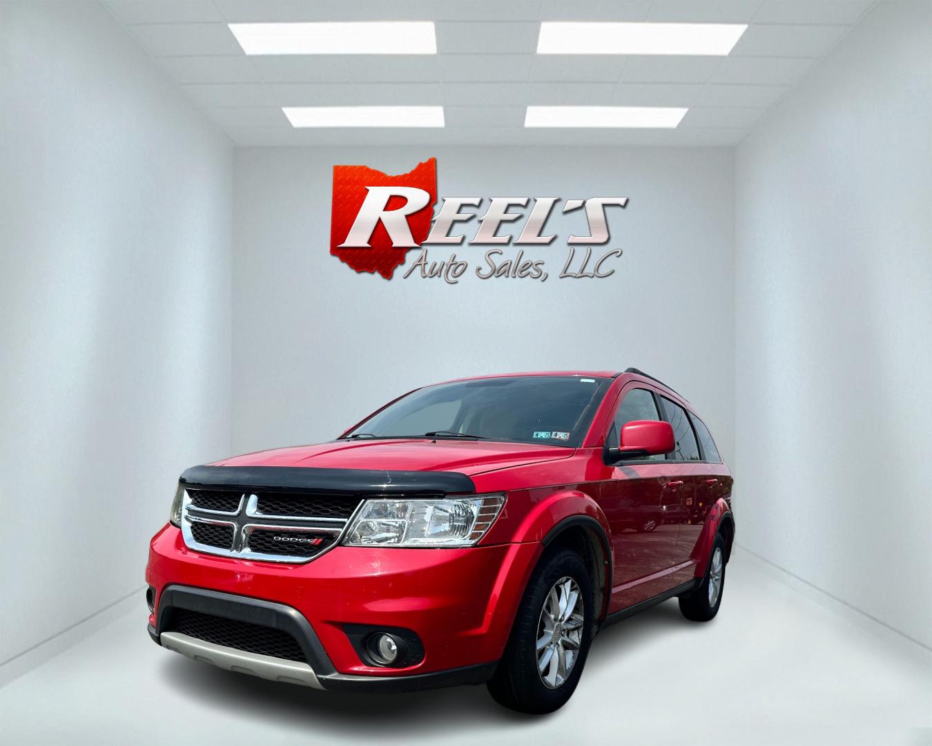 2013 Red /Tan Dodge Journey SXT (3C4PDCBG6DT) with an 3.6L V6 DOHC 24V engine, 6-Speed Automatic transmission, located at 11115 Chardon Rd. , Chardon, OH, 44024, (440) 214-9705, 41.580246, -81.241943 - This 2013 Dodge Journey SXT FWD with a 3.6 Pentastar V6 engine and 6-speed automatic transmission offers a solid blend of performance and practicality. Designed to accommodate seven passengers, it features tri-zone manual climate control to ensure comfort for everyone on board. Key amenities include - Photo#0