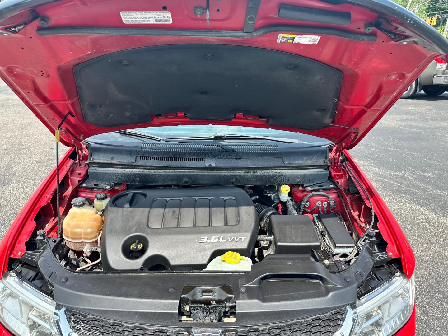 2013 Red /Tan Dodge Journey SXT (3C4PDCBG6DT) with an 3.6L V6 DOHC 24V engine, 6-Speed Automatic transmission, located at 11115 Chardon Rd. , Chardon, OH, 44024, (440) 214-9705, 41.580246, -81.241943 - This 2013 Dodge Journey SXT FWD with a 3.6 Pentastar V6 engine and 6-speed automatic transmission offers a solid blend of performance and practicality. Designed to accommodate seven passengers, it features tri-zone manual climate control to ensure comfort for everyone on board. Key amenities include - Photo#9