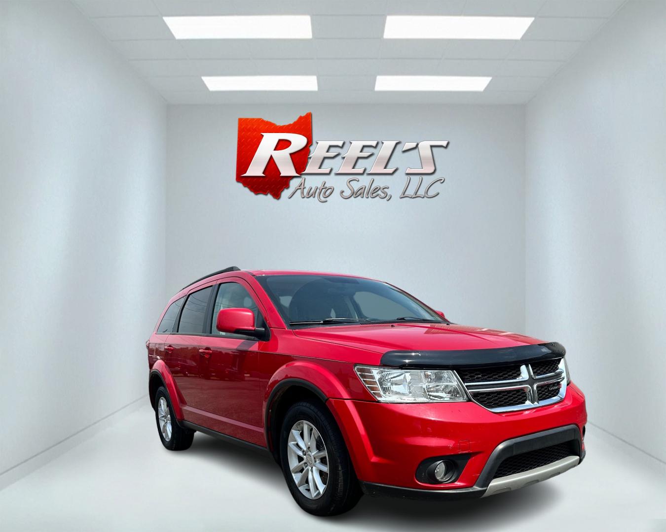 2013 Red /Tan Dodge Journey SXT (3C4PDCBG6DT) with an 3.6L V6 DOHC 24V engine, 6-Speed Automatic transmission, located at 11115 Chardon Rd. , Chardon, OH, 44024, (440) 214-9705, 41.580246, -81.241943 - This 2013 Dodge Journey SXT FWD with a 3.6 Pentastar V6 engine and 6-speed automatic transmission offers a solid blend of performance and practicality. Designed to accommodate seven passengers, it features tri-zone manual climate control to ensure comfort for everyone on board. Key amenities include - Photo#2