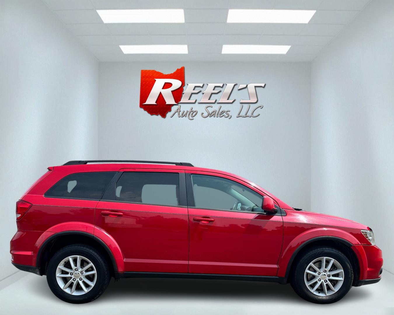 2013 Red /Tan Dodge Journey SXT (3C4PDCBG6DT) with an 3.6L V6 DOHC 24V engine, 6-Speed Automatic transmission, located at 11115 Chardon Rd. , Chardon, OH, 44024, (440) 214-9705, 41.580246, -81.241943 - This 2013 Dodge Journey SXT FWD with a 3.6 Pentastar V6 engine and 6-speed automatic transmission offers a solid blend of performance and practicality. Designed to accommodate seven passengers, it features tri-zone manual climate control to ensure comfort for everyone on board. Key amenities include - Photo#4