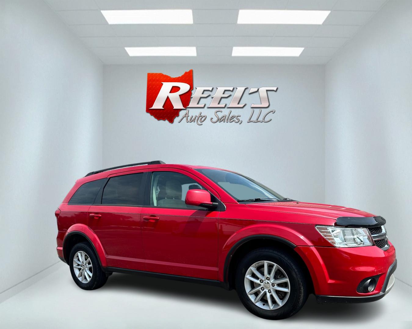 2013 Red /Tan Dodge Journey SXT (3C4PDCBG6DT) with an 3.6L V6 DOHC 24V engine, 6-Speed Automatic transmission, located at 11115 Chardon Rd. , Chardon, OH, 44024, (440) 214-9705, 41.580246, -81.241943 - This 2013 Dodge Journey SXT FWD with a 3.6 Pentastar V6 engine and 6-speed automatic transmission offers a solid blend of performance and practicality. Designed to accommodate seven passengers, it features tri-zone manual climate control to ensure comfort for everyone on board. Key amenities include - Photo#3