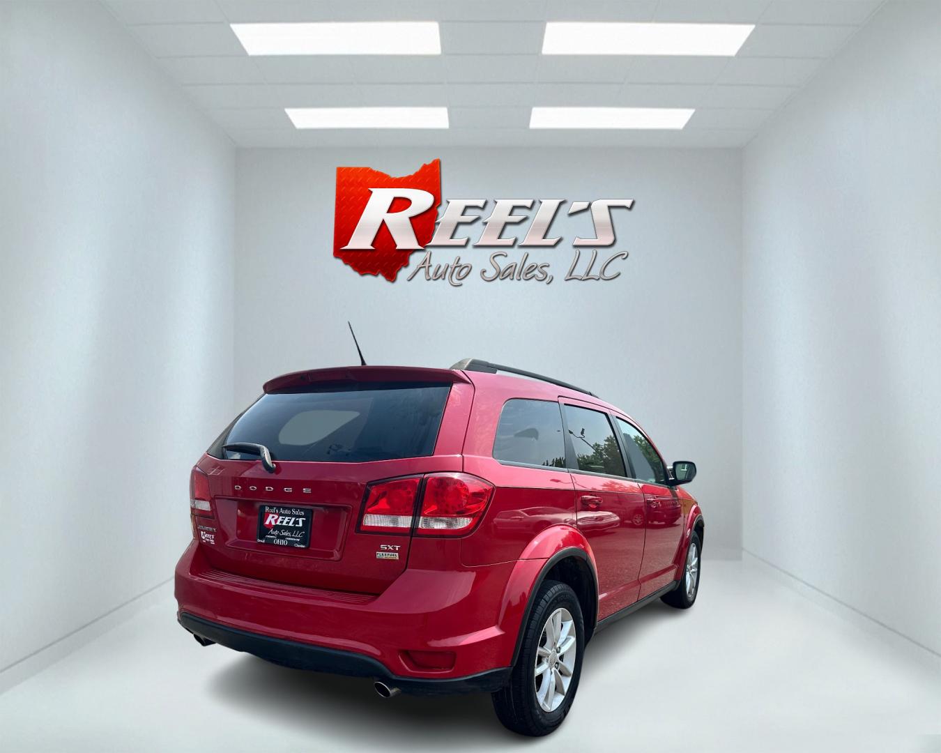 2013 Red /Tan Dodge Journey SXT (3C4PDCBG6DT) with an 3.6L V6 DOHC 24V engine, 6-Speed Automatic transmission, located at 11115 Chardon Rd. , Chardon, OH, 44024, (440) 214-9705, 41.580246, -81.241943 - This 2013 Dodge Journey SXT FWD with a 3.6 Pentastar V6 engine and 6-speed automatic transmission offers a solid blend of performance and practicality. Designed to accommodate seven passengers, it features tri-zone manual climate control to ensure comfort for everyone on board. Key amenities include - Photo#5