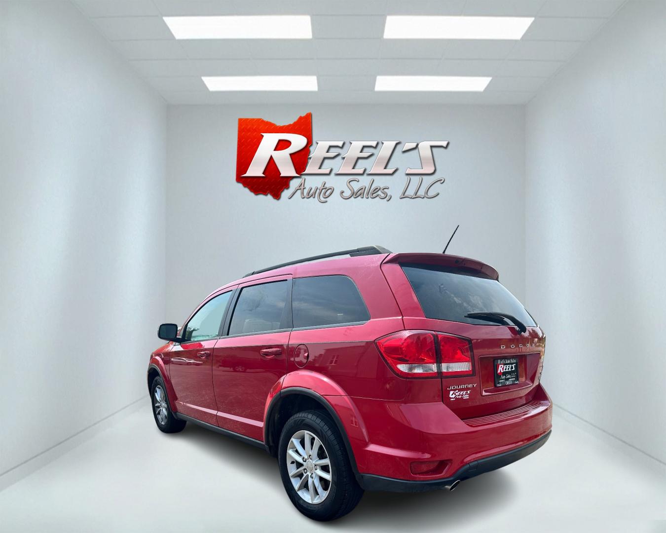 2013 Red /Tan Dodge Journey SXT (3C4PDCBG6DT) with an 3.6L V6 DOHC 24V engine, 6-Speed Automatic transmission, located at 11115 Chardon Rd. , Chardon, OH, 44024, (440) 214-9705, 41.580246, -81.241943 - This 2013 Dodge Journey SXT FWD with a 3.6 Pentastar V6 engine and 6-speed automatic transmission offers a solid blend of performance and practicality. Designed to accommodate seven passengers, it features tri-zone manual climate control to ensure comfort for everyone on board. Key amenities include - Photo#7