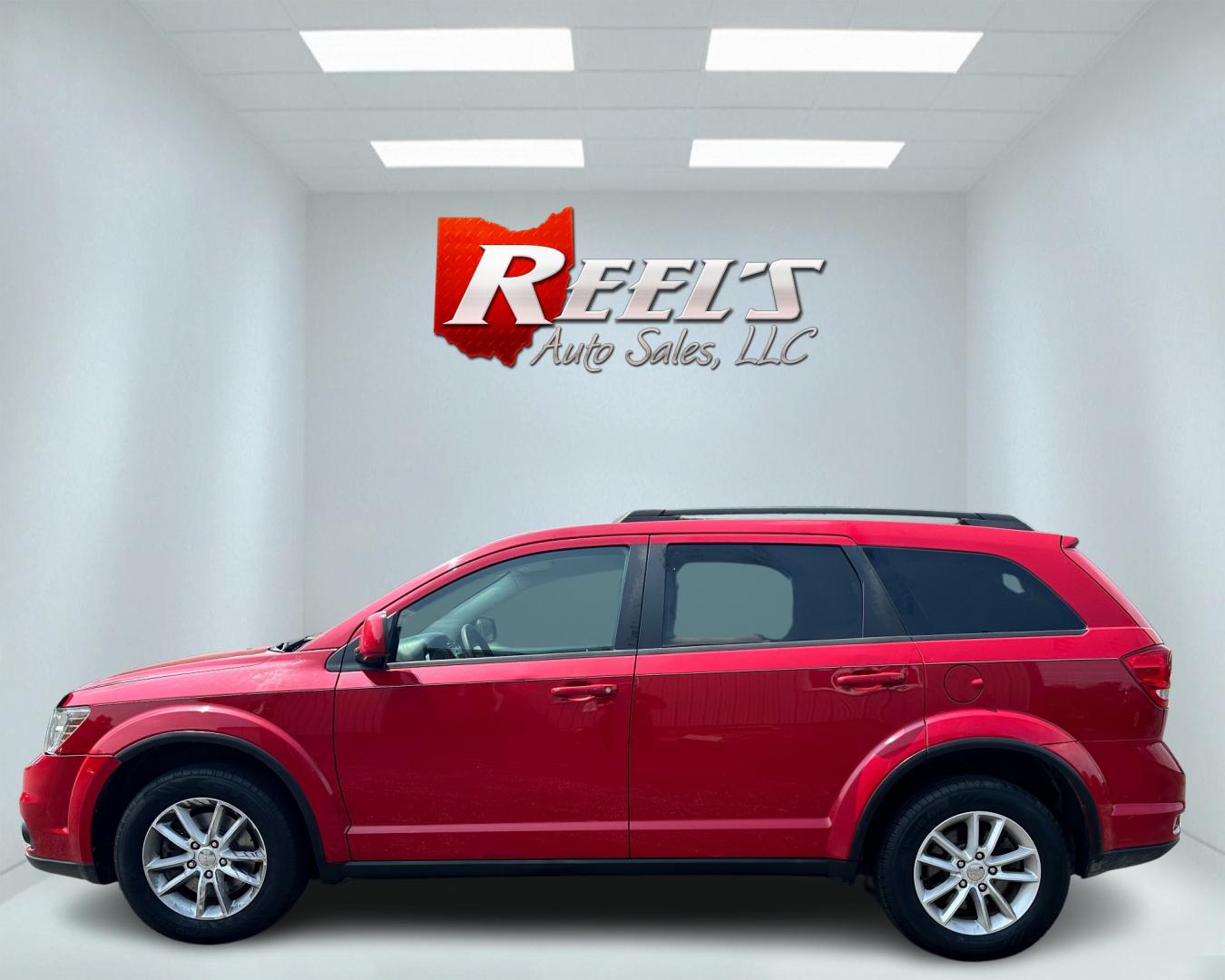 2013 Red /Tan Dodge Journey SXT (3C4PDCBG6DT) with an 3.6L V6 DOHC 24V engine, 6-Speed Automatic transmission, located at 11115 Chardon Rd. , Chardon, OH, 44024, (440) 214-9705, 41.580246, -81.241943 - This 2013 Dodge Journey SXT FWD with a 3.6 Pentastar V6 engine and 6-speed automatic transmission offers a solid blend of performance and practicality. Designed to accommodate seven passengers, it features tri-zone manual climate control to ensure comfort for everyone on board. Key amenities include - Photo#8