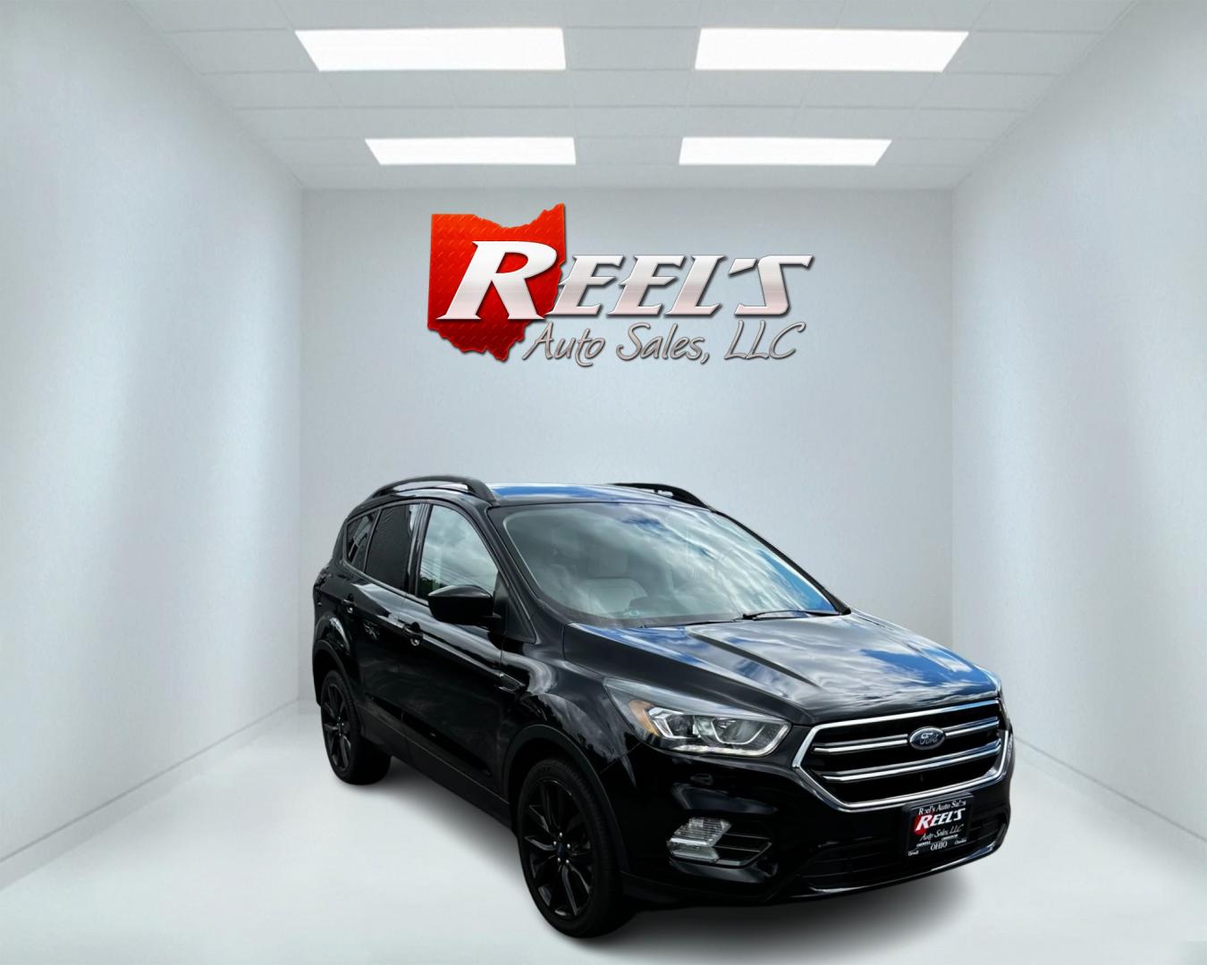 2018 Black /White Ford Escape SEL 4WD (1FMCU9HD1JU) with an 1.5L I4 DOHC 16V TURBO engine, 6A transmission, located at 547 E. Main St., Orwell, OH, 44076, (440) 437-5893, 41.535435, -80.847855 - This 2018 Ford Escape SEL 4WD is a well-equipped compact SUV that offers a blend of performance, comfort, and technology. It features a 1.5-liter EcoBoost engine paired with a 6-speed automatic transmission, providing efficient power delivery to all four wheels. The interior boasts leather seating w - Photo#2