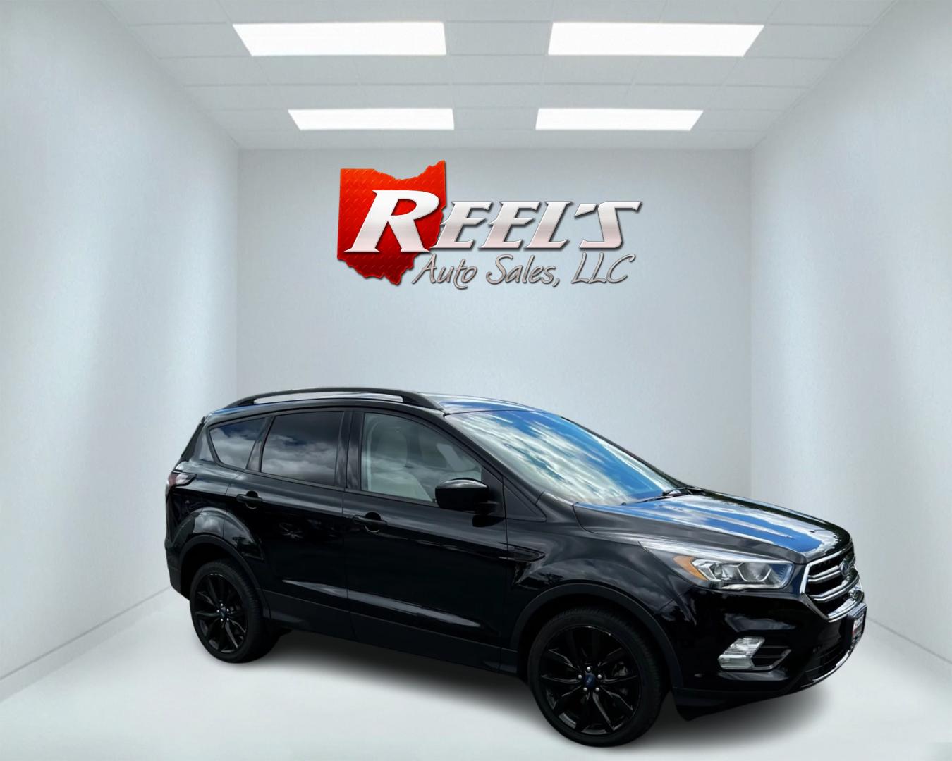 2018 Black /White Ford Escape SEL 4WD (1FMCU9HD1JU) with an 1.5L I4 DOHC 16V TURBO engine, 6A transmission, located at 547 E. Main St., Orwell, OH, 44076, (440) 437-5893, 41.535435, -80.847855 - This 2018 Ford Escape SEL 4WD is a well-equipped compact SUV that offers a blend of performance, comfort, and technology. It features a 1.5-liter EcoBoost engine paired with a 6-speed automatic transmission, providing efficient power delivery to all four wheels. The interior boasts leather seating w - Photo#3