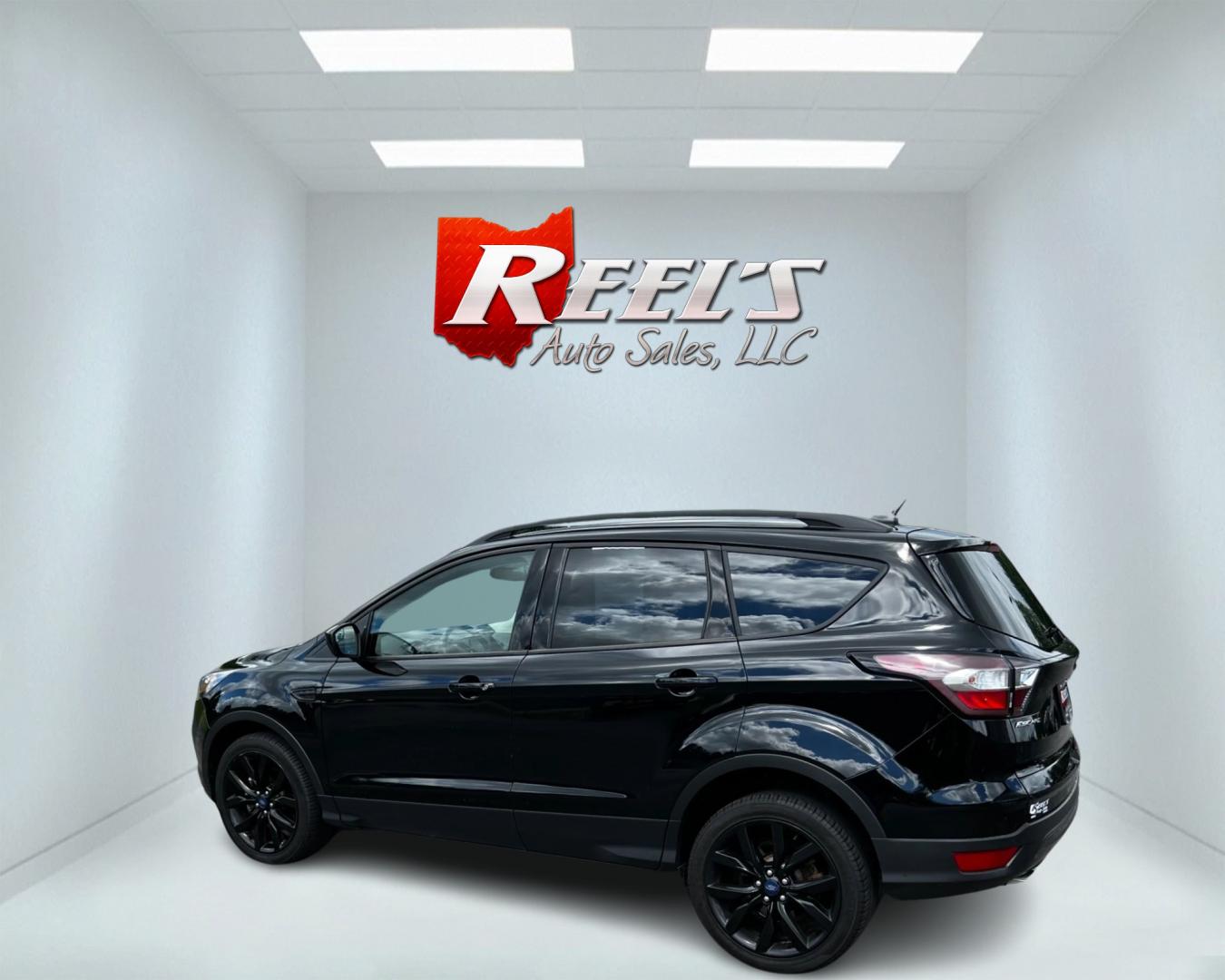 2018 Black /White Ford Escape SEL 4WD (1FMCU9HD1JU) with an 1.5L I4 DOHC 16V TURBO engine, 6A transmission, located at 547 E. Main St., Orwell, OH, 44076, (440) 437-5893, 41.535435, -80.847855 - This 2018 Ford Escape SEL 4WD is a well-equipped compact SUV that offers a blend of performance, comfort, and technology. It features a 1.5-liter EcoBoost engine paired with a 6-speed automatic transmission, providing efficient power delivery to all four wheels. The interior boasts leather seating w - Photo#7