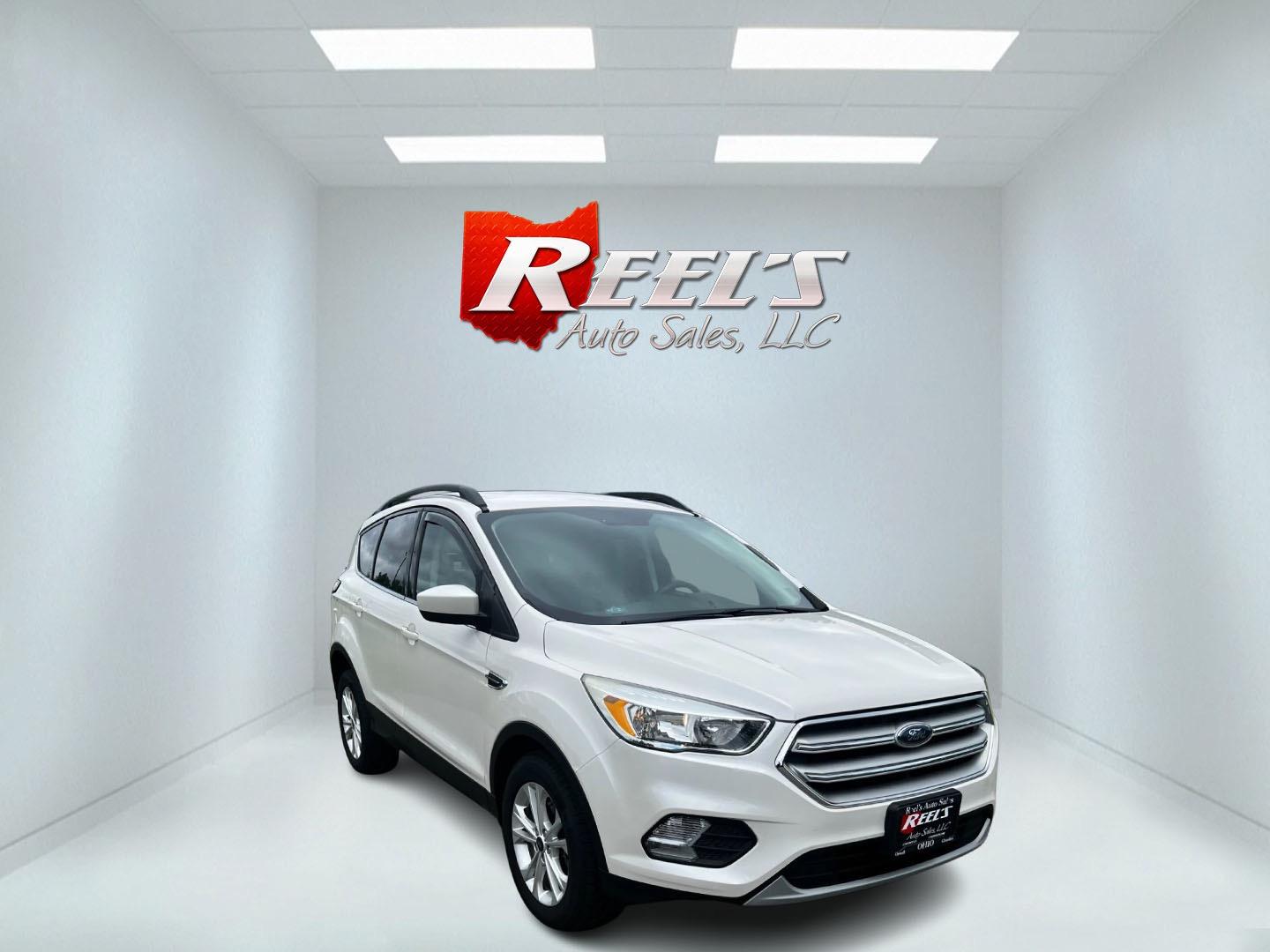 2018 White /Black Ford Escape SE 4WD (1FMCU9GD6JU) with an 1.5L I4 DOHC 16V TURBO engine, 6-Speed Automatic transmission, located at 11115 Chardon Rd. , Chardon, OH, 44024, (440) 214-9705, 41.580246, -81.241943 - This 2018 Ford Escape SE 4WD is a compact SUV equipped with a 1.5-liter turbocharged I4 EcoBoost engine paired with a 6-speed automatic transmission. It offers good fuel efficiency with 28 MPG on the highway. The vehicle features convenience amenities such as a power driver's seat and dual-zone auto - Photo#2