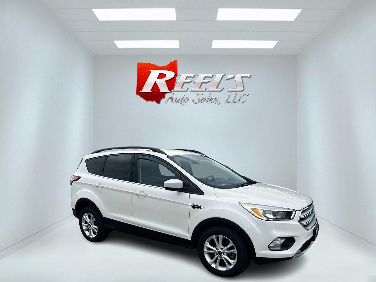 2018 White /Black Ford Escape SE 4WD (1FMCU9GD6JU) with an 1.5L I4 DOHC 16V TURBO engine, 6-Speed Automatic transmission, located at 11115 Chardon Rd. , Chardon, OH, 44024, (440) 214-9705, 41.580246, -81.241943 - This 2018 Ford Escape SE 4WD is a compact SUV equipped with a 1.5-liter turbocharged I4 EcoBoost engine paired with a 6-speed automatic transmission. It offers good fuel efficiency with 28 MPG on the highway. The vehicle features convenience amenities such as a power driver's seat and dual-zone auto - Photo#3