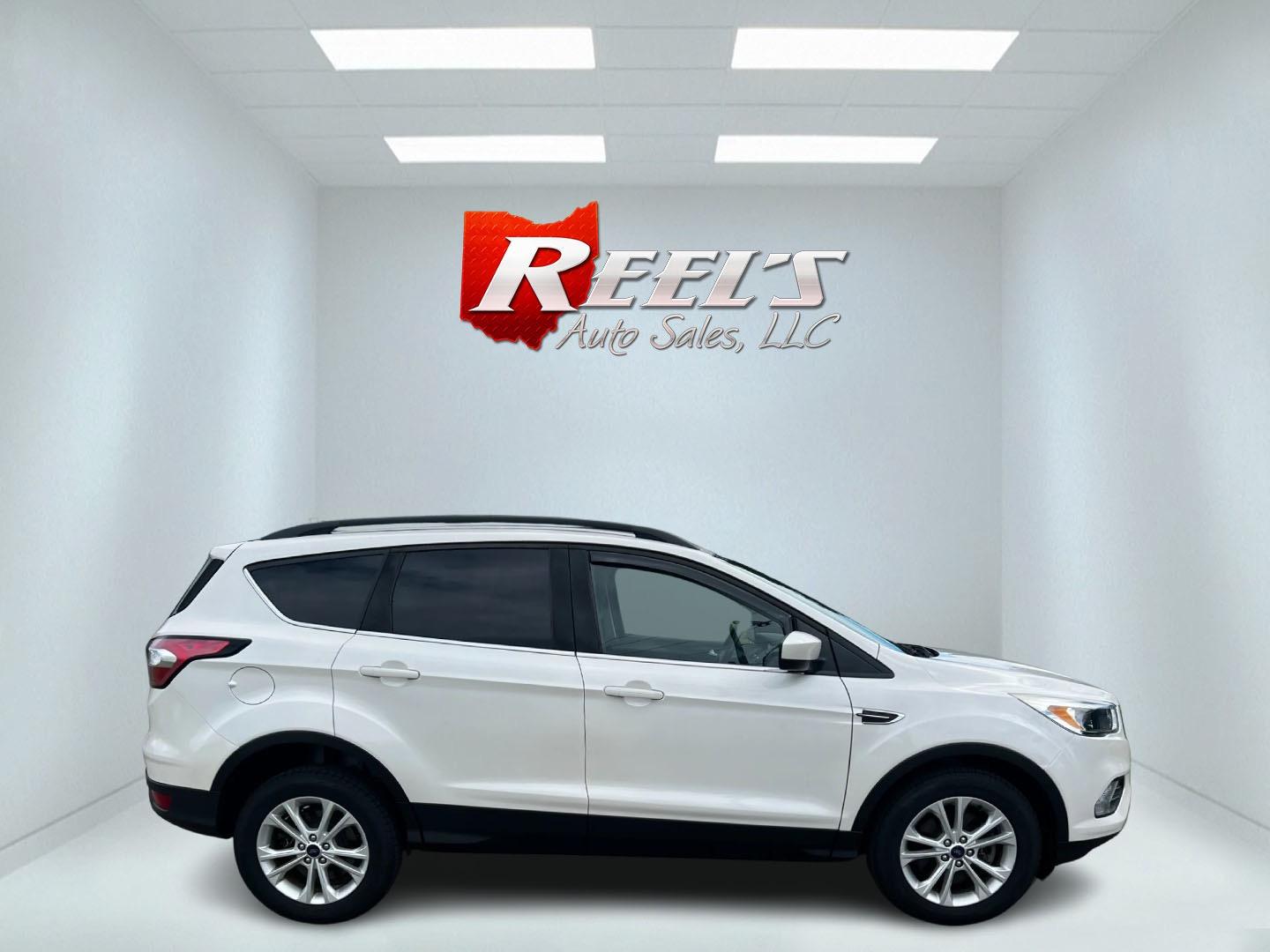 2018 White /Black Ford Escape SE 4WD (1FMCU9GD6JU) with an 1.5L I4 DOHC 16V TURBO engine, 6-Speed Automatic transmission, located at 11115 Chardon Rd. , Chardon, OH, 44024, (440) 214-9705, 41.580246, -81.241943 - This 2018 Ford Escape SE 4WD is a compact SUV equipped with a 1.5-liter turbocharged I4 EcoBoost engine paired with a 6-speed automatic transmission. It offers good fuel efficiency with 28 MPG on the highway. The vehicle features convenience amenities such as a power driver's seat and dual-zone auto - Photo#39