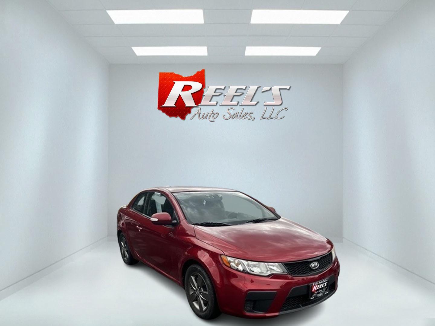 2010 Red /Black Kia Forte Koup EX (KNAFU6A29A5) with an 2.0L I4 DOHC 16V engine, 4 Speed Auto transmission, located at 547 E. Main St., Orwell, OH, 44076, (440) 437-5893, 41.535435, -80.847855 - This 2010 Kia Forte Koup EX is a compact coupe that offers a blend of style, efficiency, and practicality. It's powered by a 2.0-liter inline-four engine paired with a 4-speed automatic transmission, providing adequate performance for daily driving. This Forte Koup stands out for its impressive fuel - Photo#2