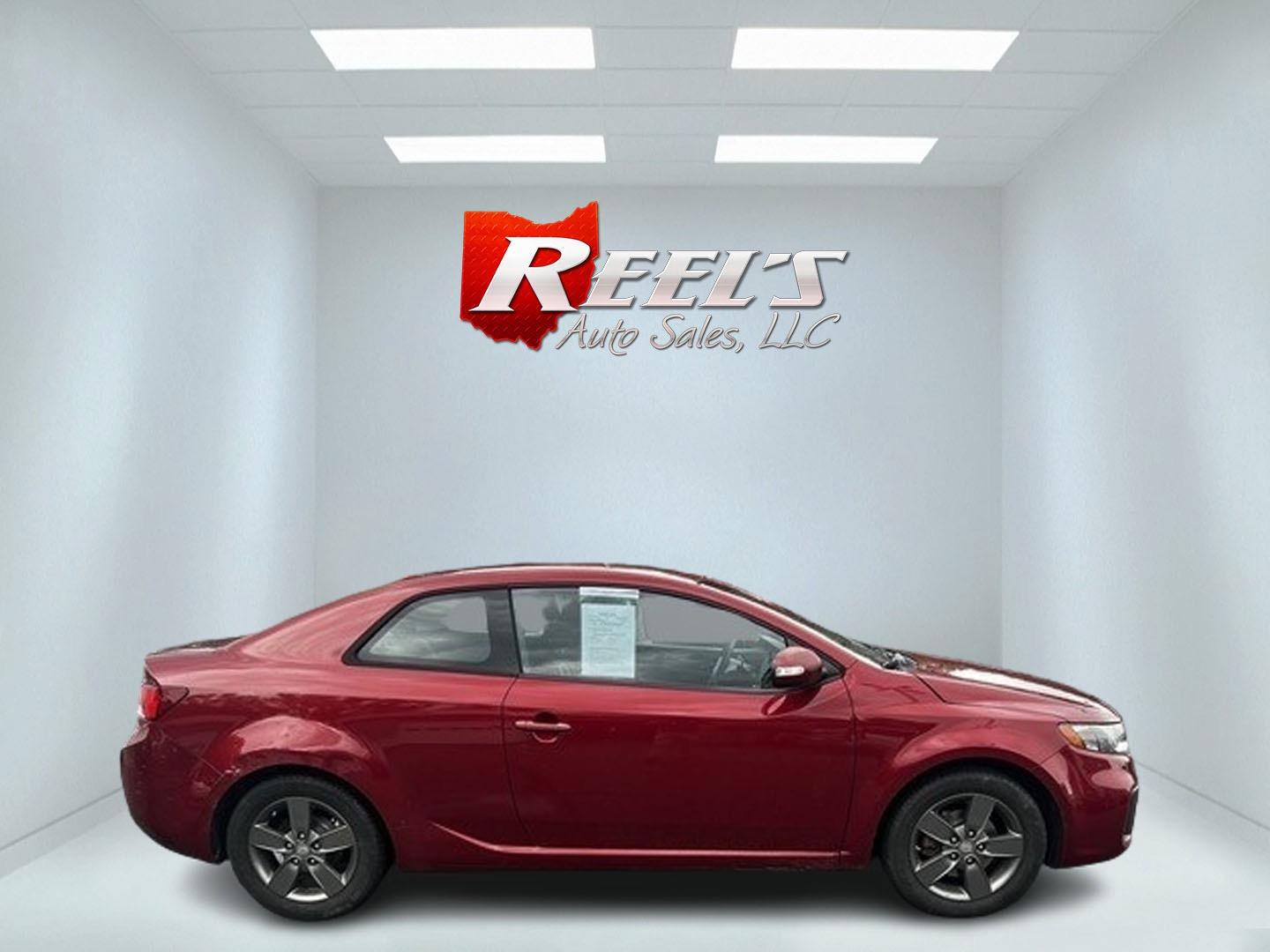 2010 Red /Black Kia Forte Koup EX (KNAFU6A29A5) with an 2.0L I4 DOHC 16V engine, 4 Speed Auto transmission, located at 547 E. Main St., Orwell, OH, 44076, (440) 437-5893, 41.535435, -80.847855 - This 2010 Kia Forte Koup EX is a compact coupe that offers a blend of style, efficiency, and practicality. It's powered by a 2.0-liter inline-four engine paired with a 4-speed automatic transmission, providing adequate performance for daily driving. This Forte Koup stands out for its impressive fuel - Photo#4