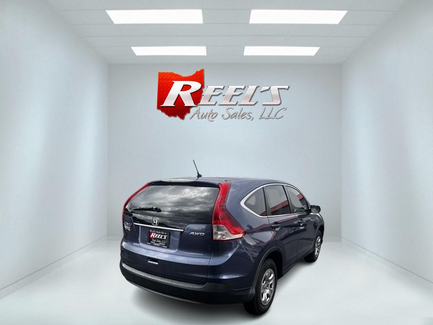 2013 Blue /Gray Honda CR-V LX 4WD 5-Speed AT (2HKRM4H35DH) with an 2.4L I4 DOHC 16V engine, 5-Speed Automatic transmission, located at 547 E. Main St., Orwell, OH, 44076, (440) 437-5893, 41.535435, -80.847855 - This 2013 Honda CR-V LX 4WD is a reliable and practical compact SUV that offers a good balance of efficiency and capability. It's powered by a 2.4-liter inline-four engine paired with a 5-speed automatic transmission, providing adequate performance for daily driving and light off-road use. The 4WD s - Photo#5