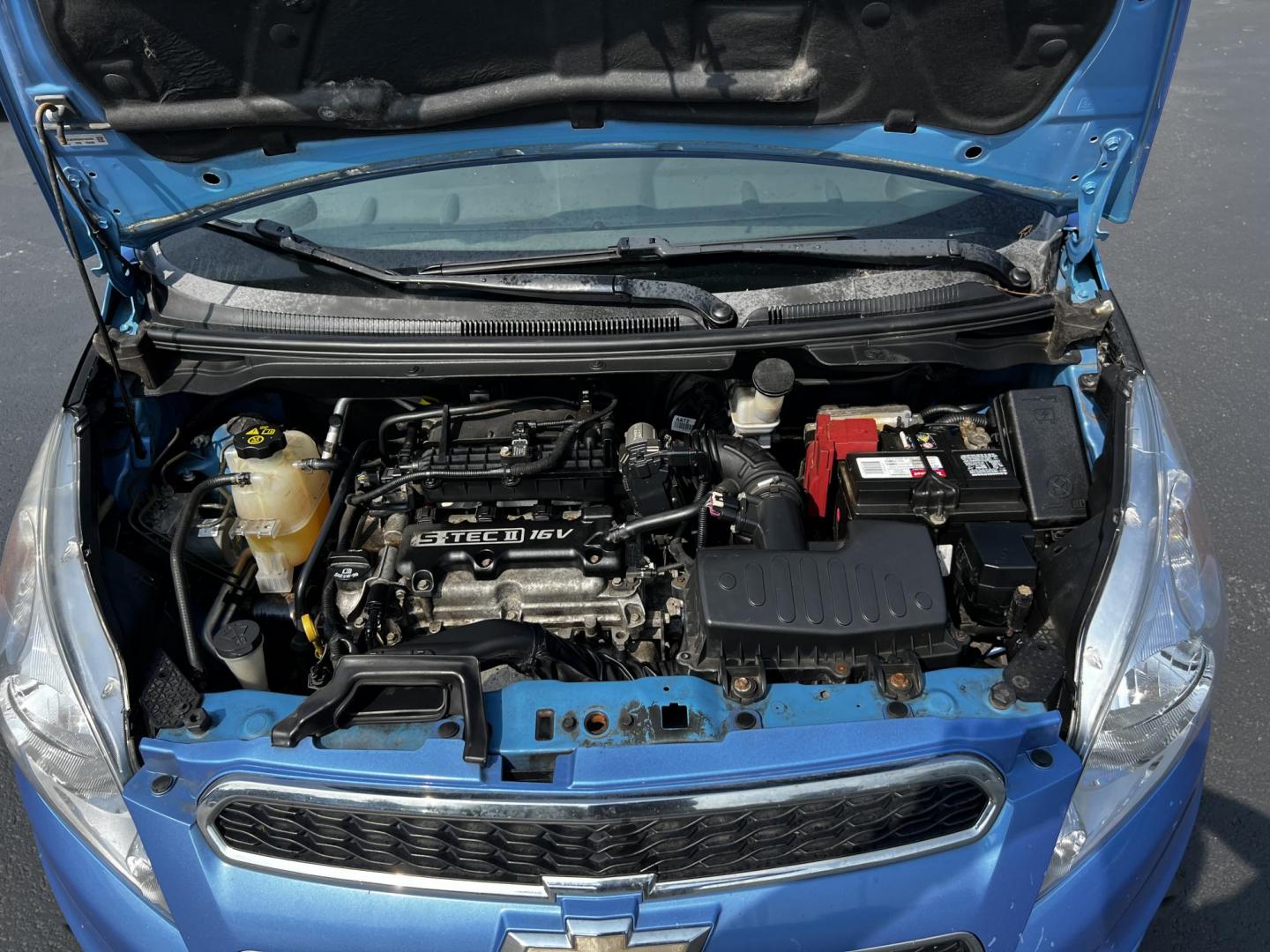 2014 Blue /Black Chevrolet Spark LS Auto (KL8CB6S9XEC) with an 1.2L I4 16V DOHC engine, Automatic transmission, located at 11115 Chardon Rd. , Chardon, OH, 44024, (440) 214-9705, 41.580246, -81.241943 - This 2014 Chevrolet Spark LS is a compact hatchback equipped with a 1.2 I4 engine and a CVT transmission, designed to offer efficiency and practicality for urban driving. It features daytime running lights and dusk-sensing headlights for improved visibility and safety. The Spark delivers a respectab - Photo#14