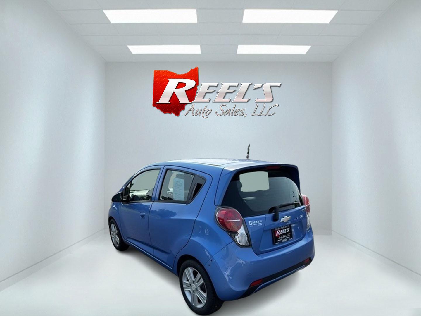 2014 Blue /Black Chevrolet Spark LS Auto (KL8CB6S9XEC) with an 1.2L I4 16V DOHC engine, Automatic transmission, located at 11115 Chardon Rd. , Chardon, OH, 44024, (440) 214-9705, 41.580246, -81.241943 - This 2014 Chevrolet Spark LS is a compact hatchback equipped with a 1.2 I4 engine and a CVT transmission, designed to offer efficiency and practicality for urban driving. It features daytime running lights and dusk-sensing headlights for improved visibility and safety. The Spark delivers a respectab - Photo#7