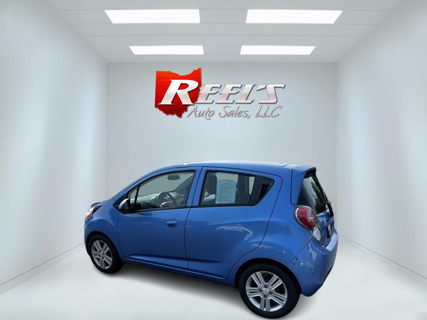 2014 Blue /Black Chevrolet Spark LS Auto (KL8CB6S9XEC) with an 1.2L I4 16V DOHC engine, Automatic transmission, located at 11115 Chardon Rd. , Chardon, OH, 44024, (440) 214-9705, 41.580246, -81.241943 - This 2014 Chevrolet Spark LS is a compact hatchback equipped with a 1.2 I4 engine and a CVT transmission, designed to offer efficiency and practicality for urban driving. It features daytime running lights and dusk-sensing headlights for improved visibility and safety. The Spark delivers a respectab - Photo#9