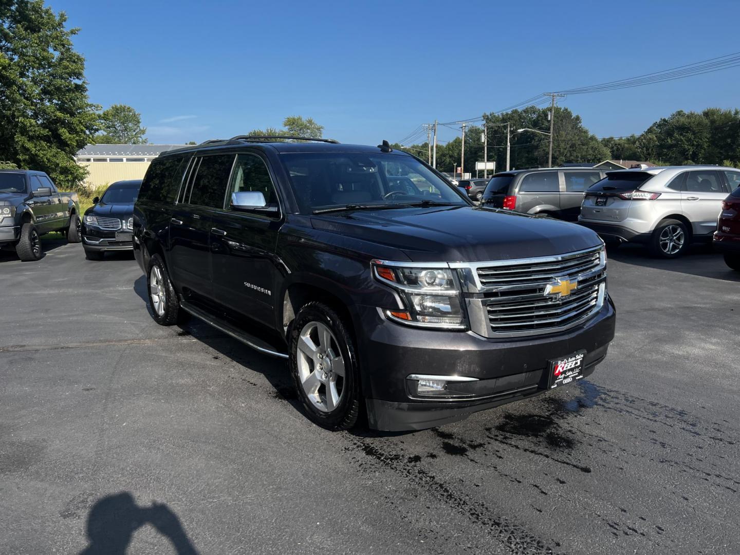 2017 Gray /Black Chevrolet Suburban Premier 4WD (1GNSKJKCXHR) with an 5.3L V8 OHV 16V engine, 6-Speed Automatic transmission, located at 547 E. Main St., Orwell, OH, 44076, (440) 437-5893, 41.535435, -80.847855 - This 2017 Chevrolet Suburban Premier 4WD is a robust full-size SUV powered by a 5.3-liter V8 Vortec engine with a 6-speed automatic transmission, offering a towing capacity of 6,000 pounds and equipped with a G80 locking rear differential and 3.08 gearing. It boasts an array of luxury and technology - Photo#1