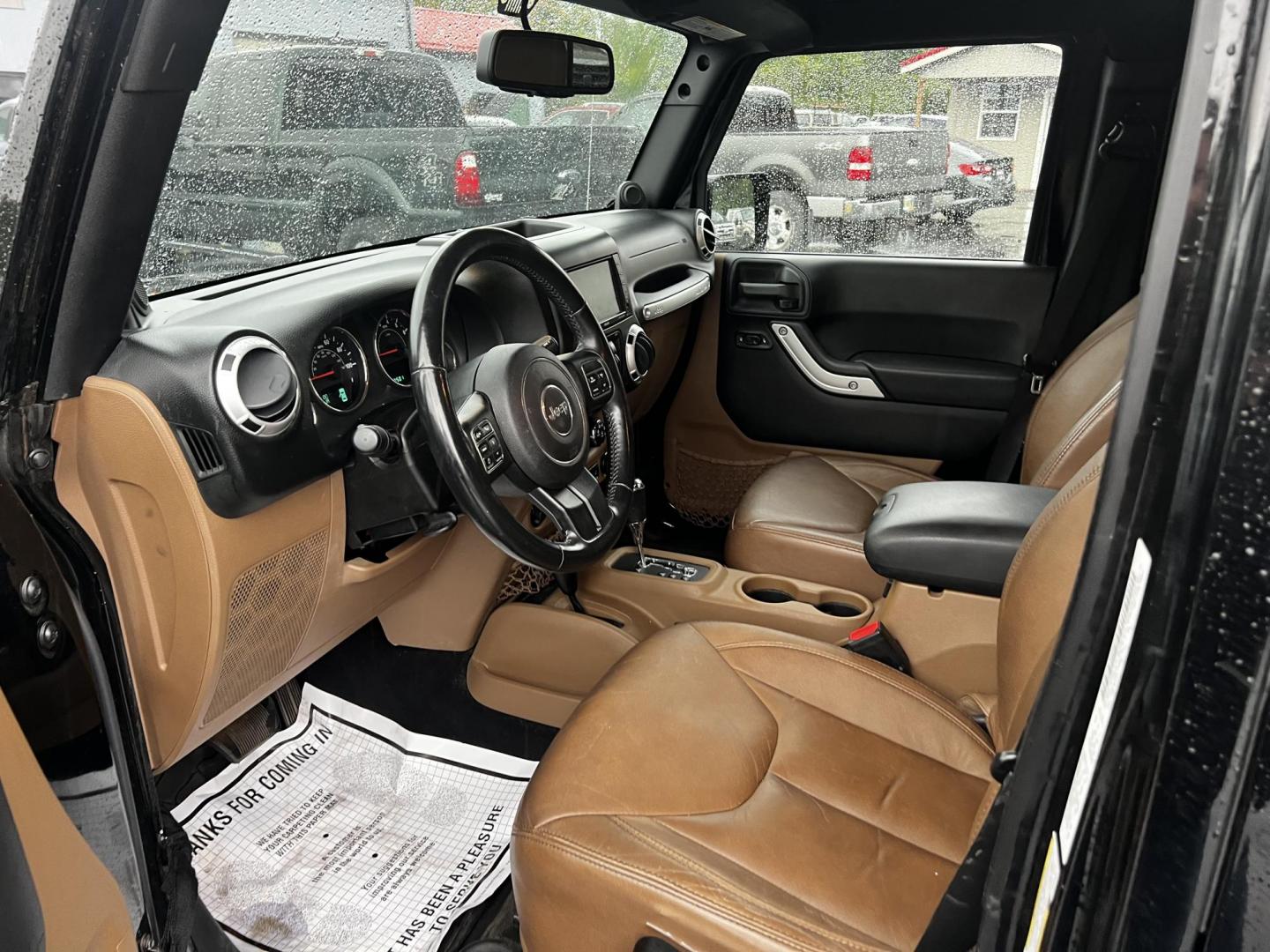 2014 Black /Brown Jeep Wrangler Unlimited Sahara 4WD (1C4BJWEG2EL) with an 3.6L V6 DOHC 24V engine, 5 Speed Auto transmission, located at 547 E. Main St., Orwell, OH, 44076, (440) 437-5893, 41.535435, -80.847855 - This 2014 Jeep Wrangler Unlimited Sahara combines rugged capability with a touch of luxury, catering to adventure enthusiasts who also enjoy comfort. Powered by a 3.6-liter Pentastar V6 engine paired with a 5-speed automatic transmission, it offers robust performance perfect for off-road escapades a - Photo#15