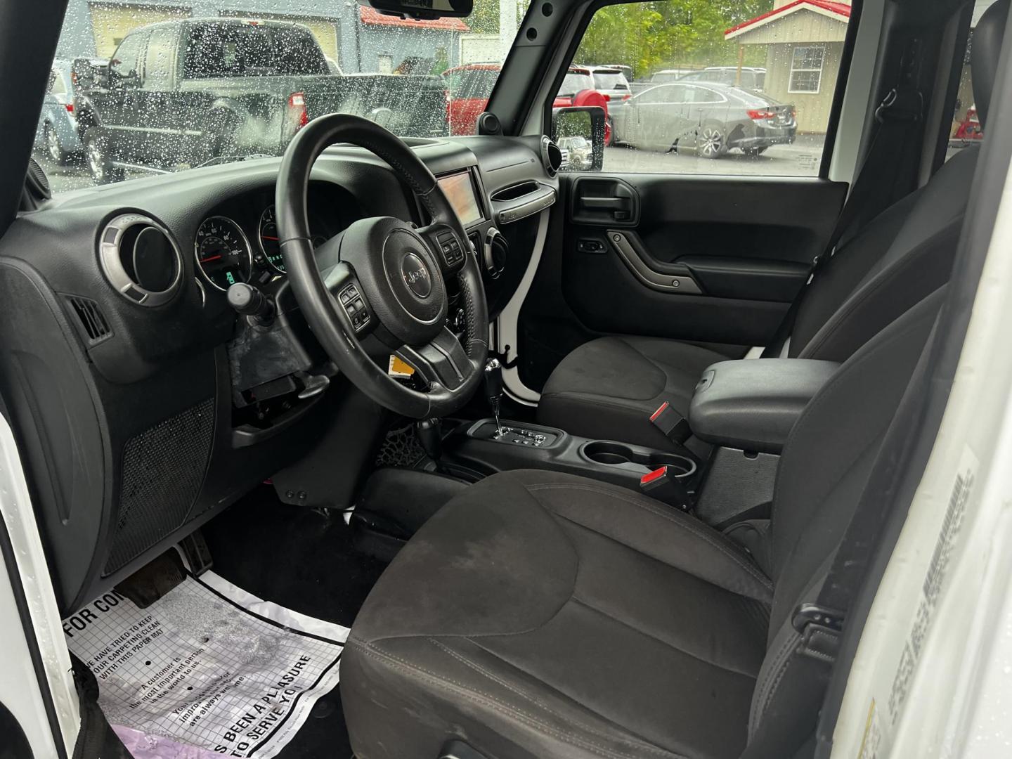 2014 White /Black Jeep Wrangler Unlimited Sport 4WD (1C4BJWDG3EL) with an 3.6L V6 DOHC 24V engine, 5 Speed Auto transmission, located at 547 E. Main St., Orwell, OH, 44076, (440) 437-5893, 41.535435, -80.847855 - This 2014 Jeep Wrangler Unlimited Sport is built for those who enjoy both adventure and practicality, featuring robust off-road capabilities and essential modern features. It's equipped with a 3.6-liter Pentastar V6 engine and a 5-speed automatic transmission, delivering reliable power and performan - Photo#14