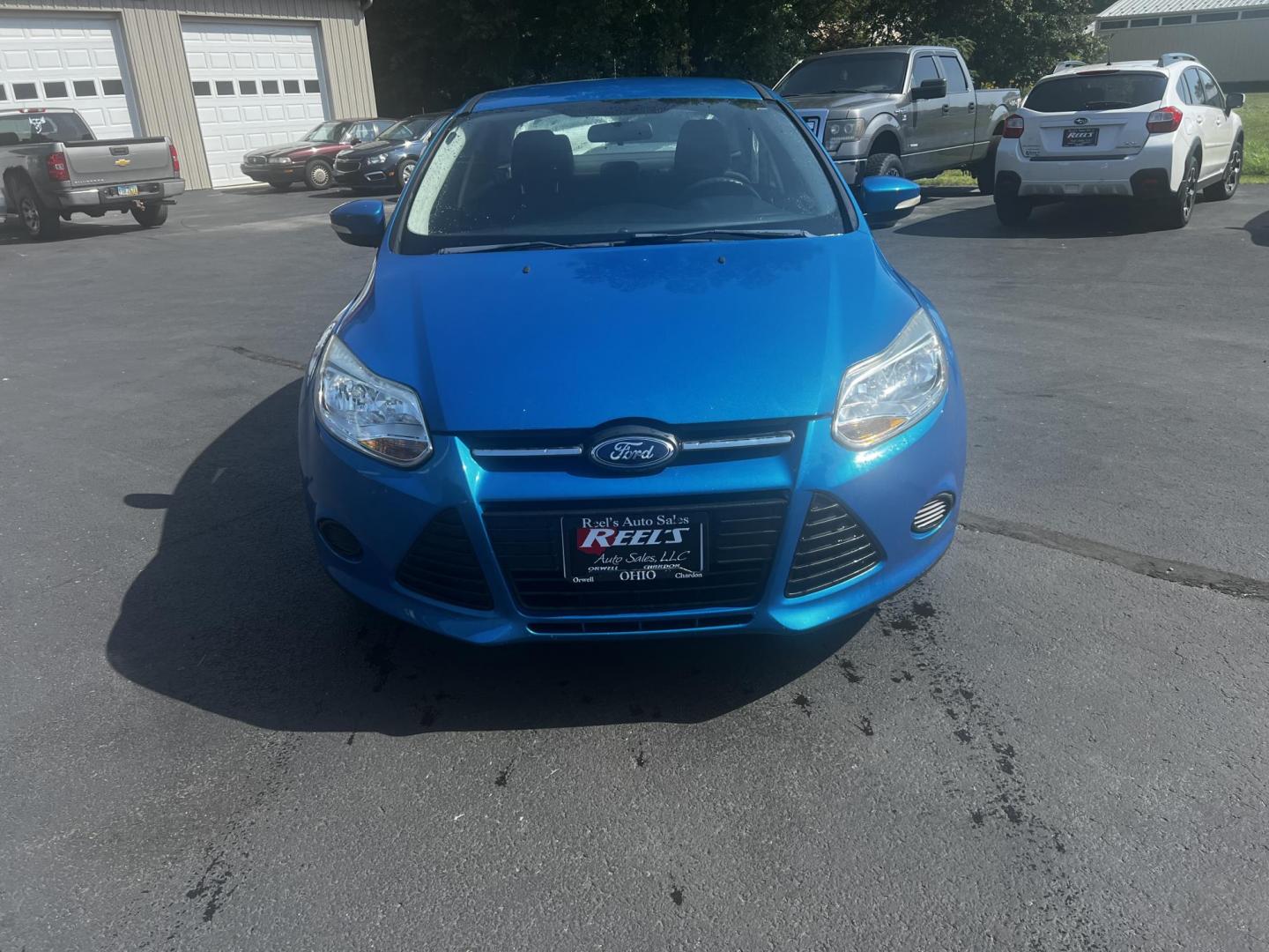 2013 Blue /Black Ford Focus SE Sedan (1FADP3F29DL) with an 2.0L I4 DOHC 16V engine, 6-Speed Automatic transmission, located at 547 E. Main St., Orwell, OH, 44076, (440) 437-5893, 41.535435, -80.847855 - Photo#1