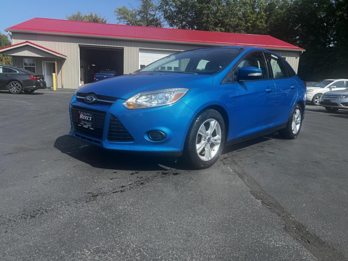 2013 Blue /Black Ford Focus SE Sedan (1FADP3F29DL) with an 2.0L I4 DOHC 16V engine, 6-Speed Automatic transmission, located at 547 E. Main St., Orwell, OH, 44076, (440) 437-5893, 41.535435, -80.847855 - Photo#0